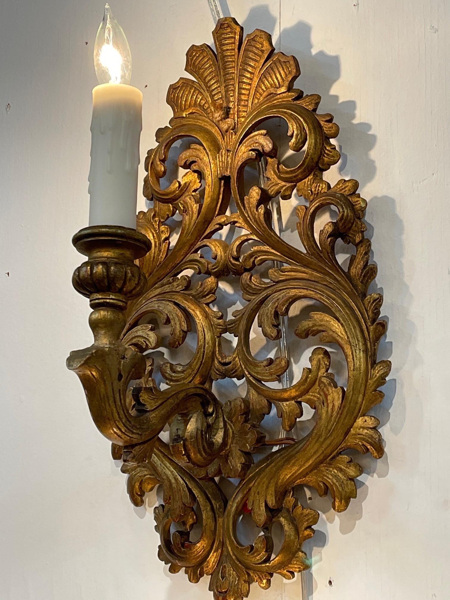 Beautiful pair of 19th century Italian carved and giltwood 1-arm sconces. Lovely scrolling pattern on these. So pretty!!