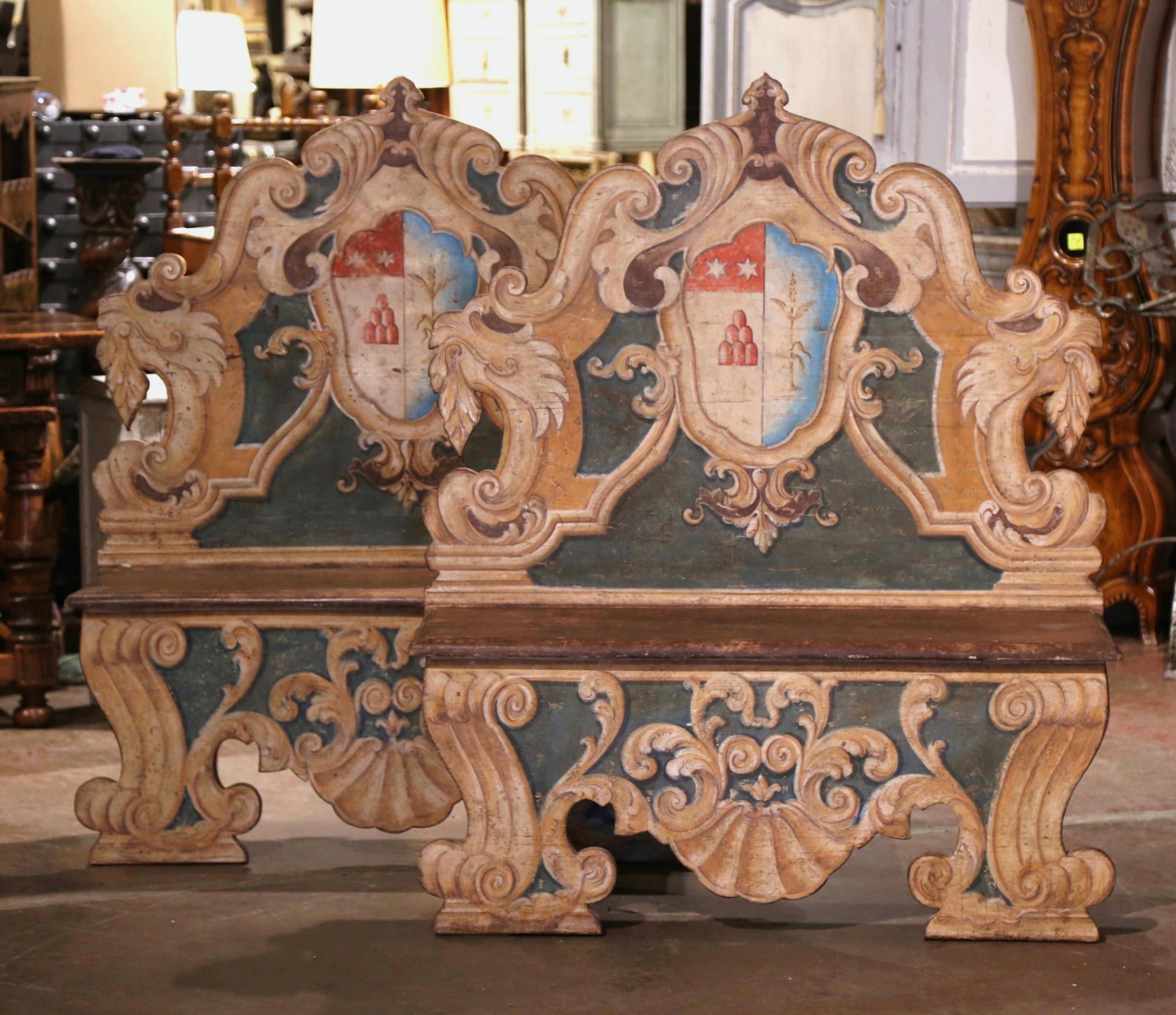 Add Italian visual drama into your home with this elegant pair of antique Cassapanca benches. Crafted in Italy, circa 1860, each carved bench features a tall back and apron decorated with intricately carved and scalloped edges; each seating is