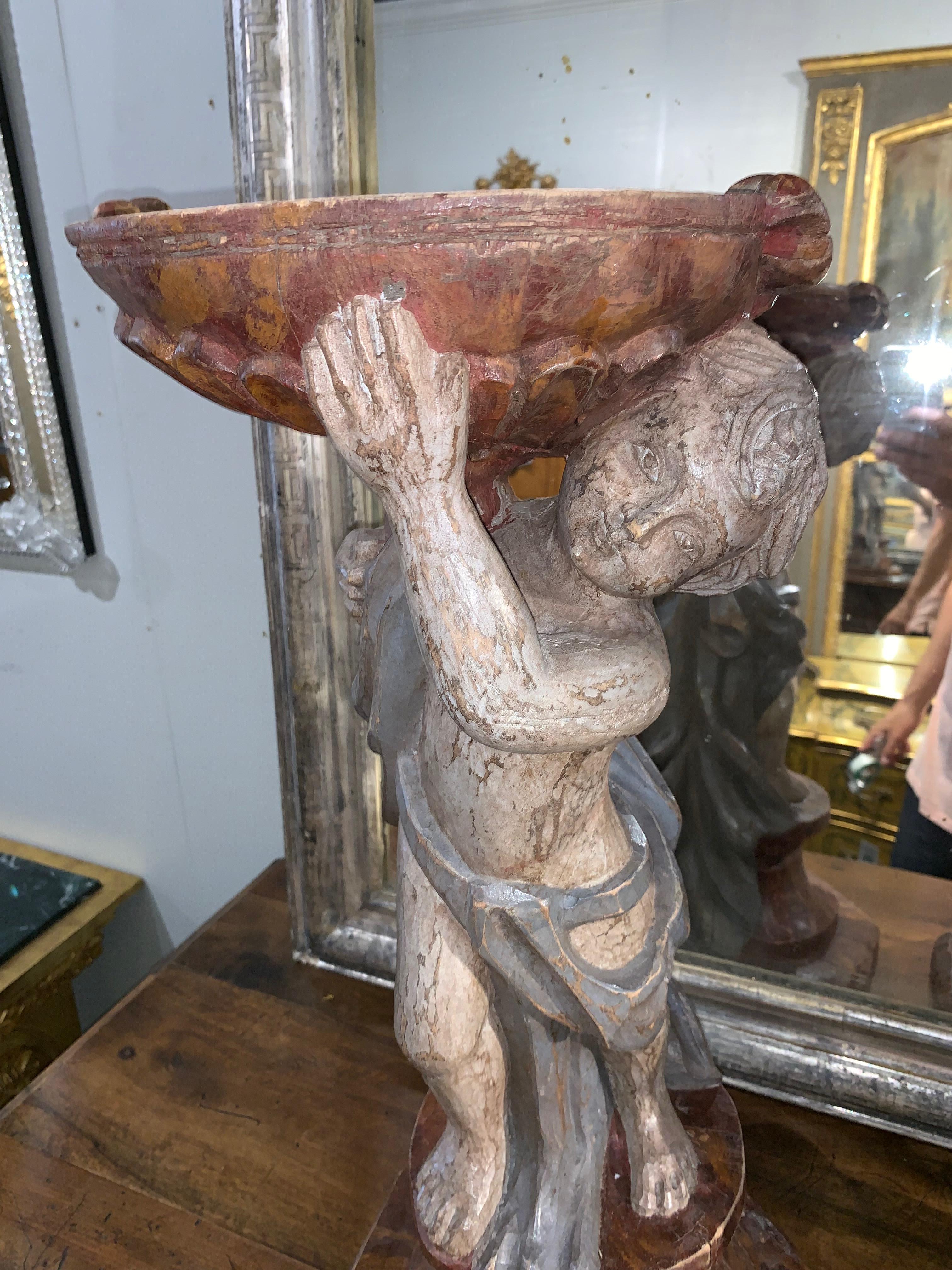 Beautiful pair of 19th century carved and painted cherub planters. Amazing color and texture to these pieces. They would look amazing in a lovely home or in a garden.