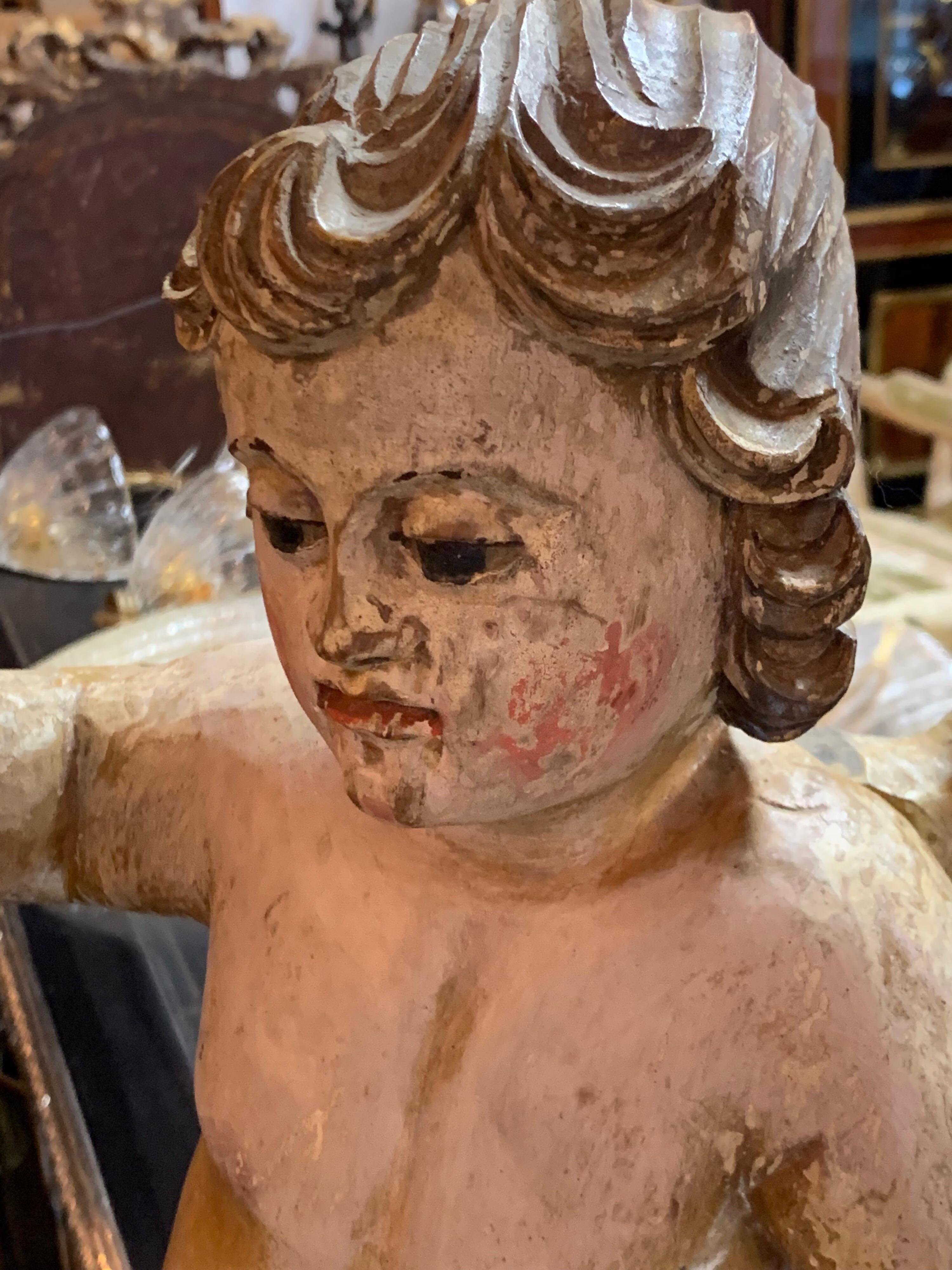 Beautiful pair of 18th century carved and painted cherubs. Exquisite carving and lovely patina on these.