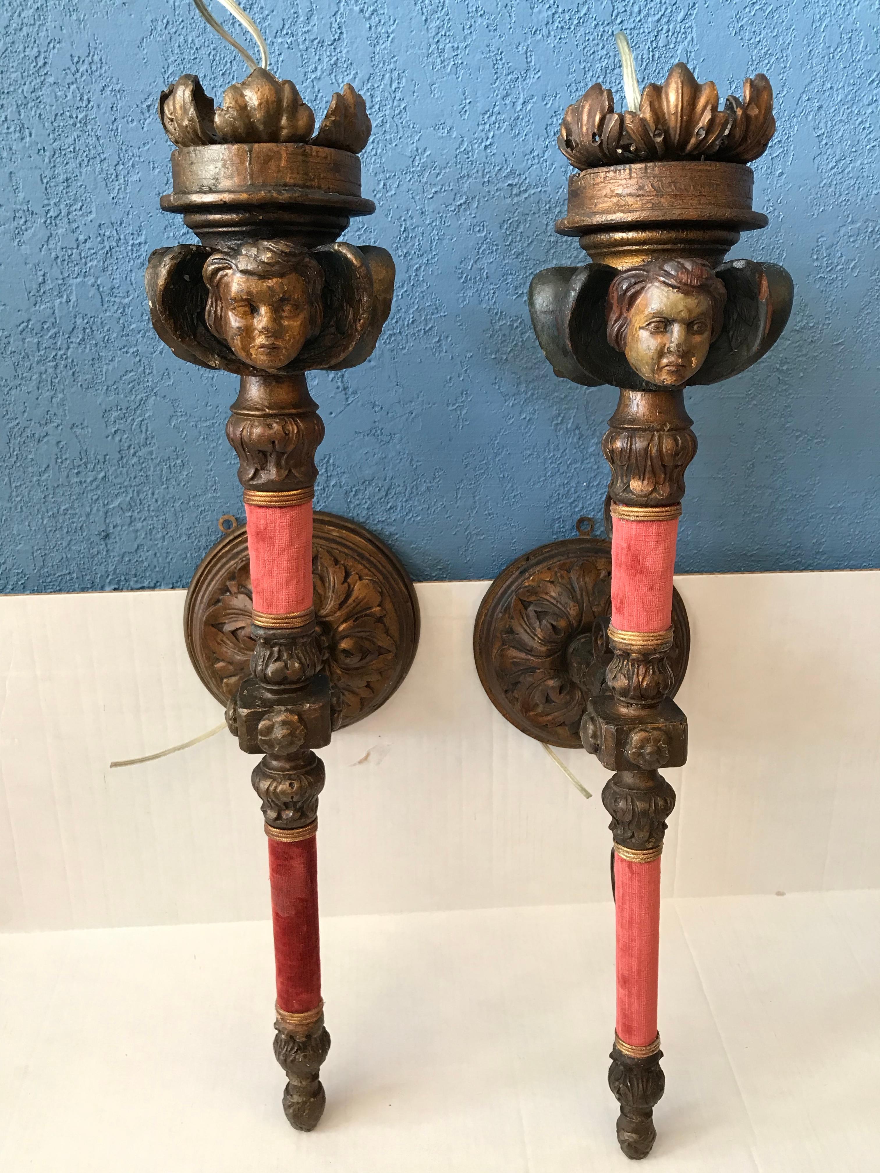 Each sconce is fashioned with 4 faces. All different personalities. The arms of the sconces are wrapped
in velvet, and the form of each like a 