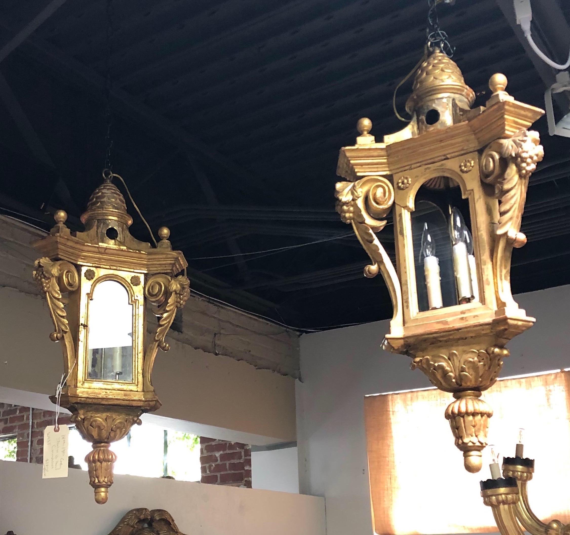 Pair of 19th century (possibly earlier) Italian carved giltwood hall lanterns with grape and scroll design.

Available individually.
 