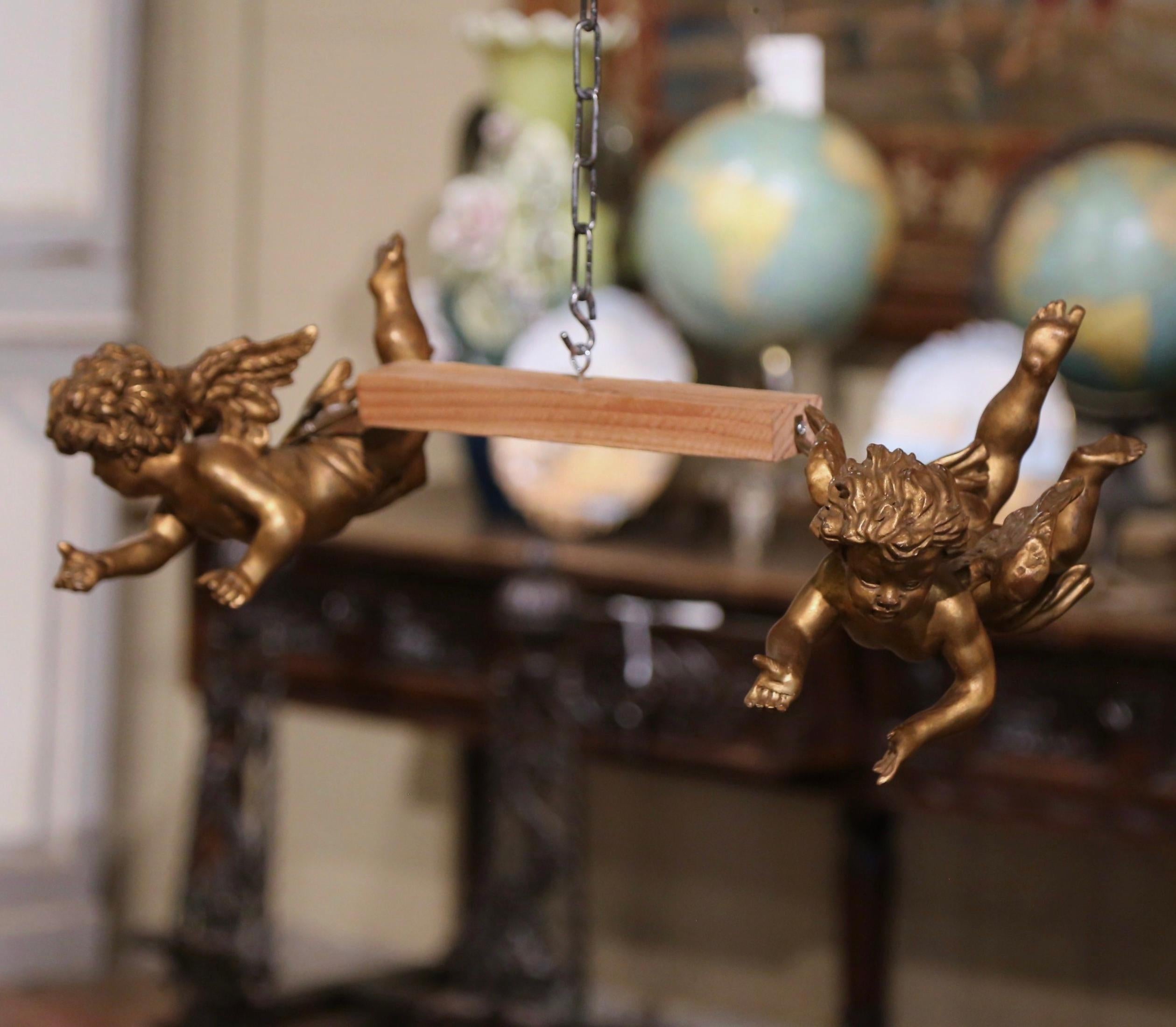 These antique winged wall cherub figures were crafted in Italy, circa 1880. The hand-painted putti carvings feature their original paint and gold leaf finish for a luxurious result. The hand carved chubby cherubs are expressive in their movement and