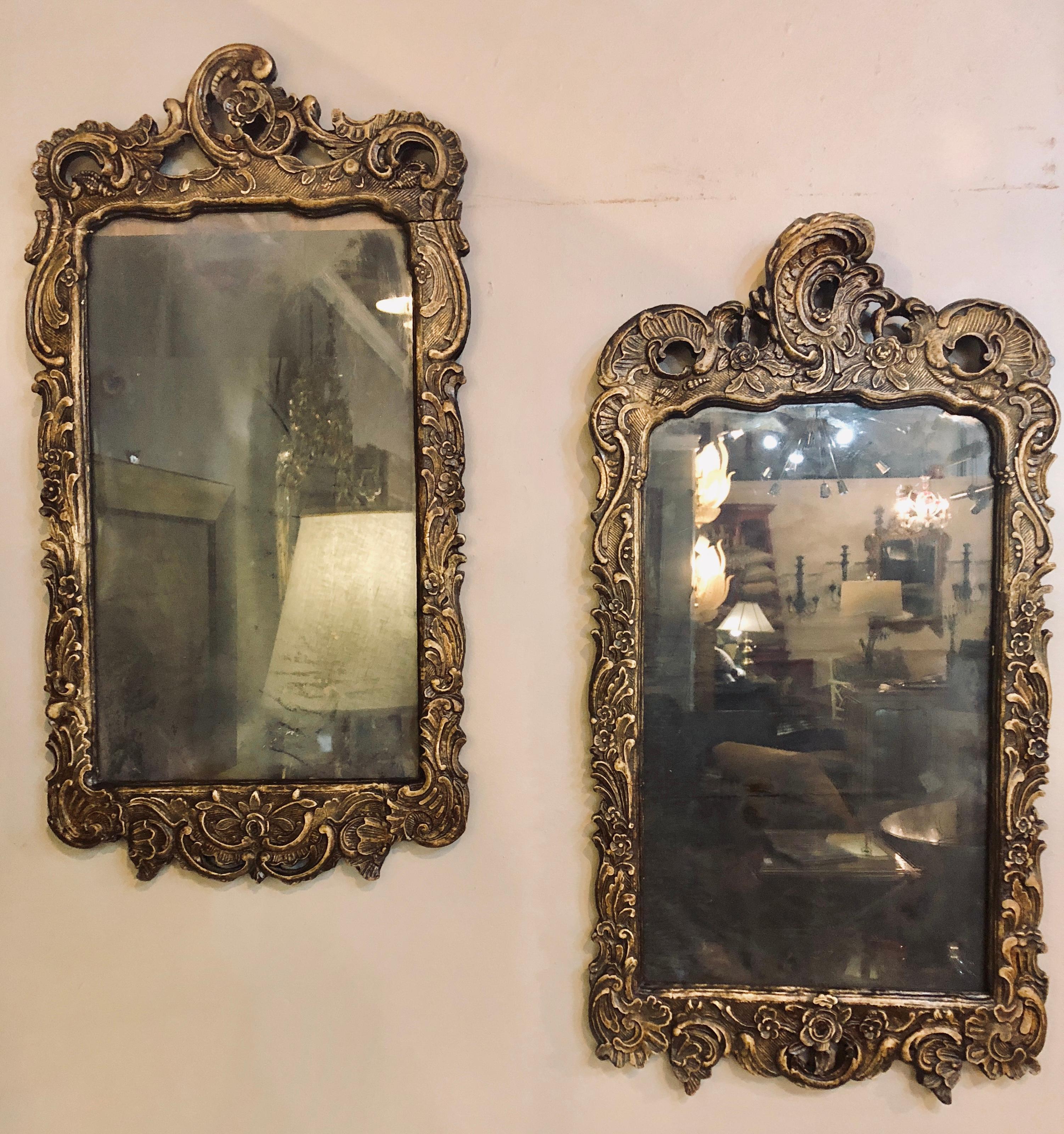 Pair Of 19th century Italian carved mirror frames. Each having a heavy distressed looking glass with a centre solid wood carved frame of scrolls, seashells and flowers.