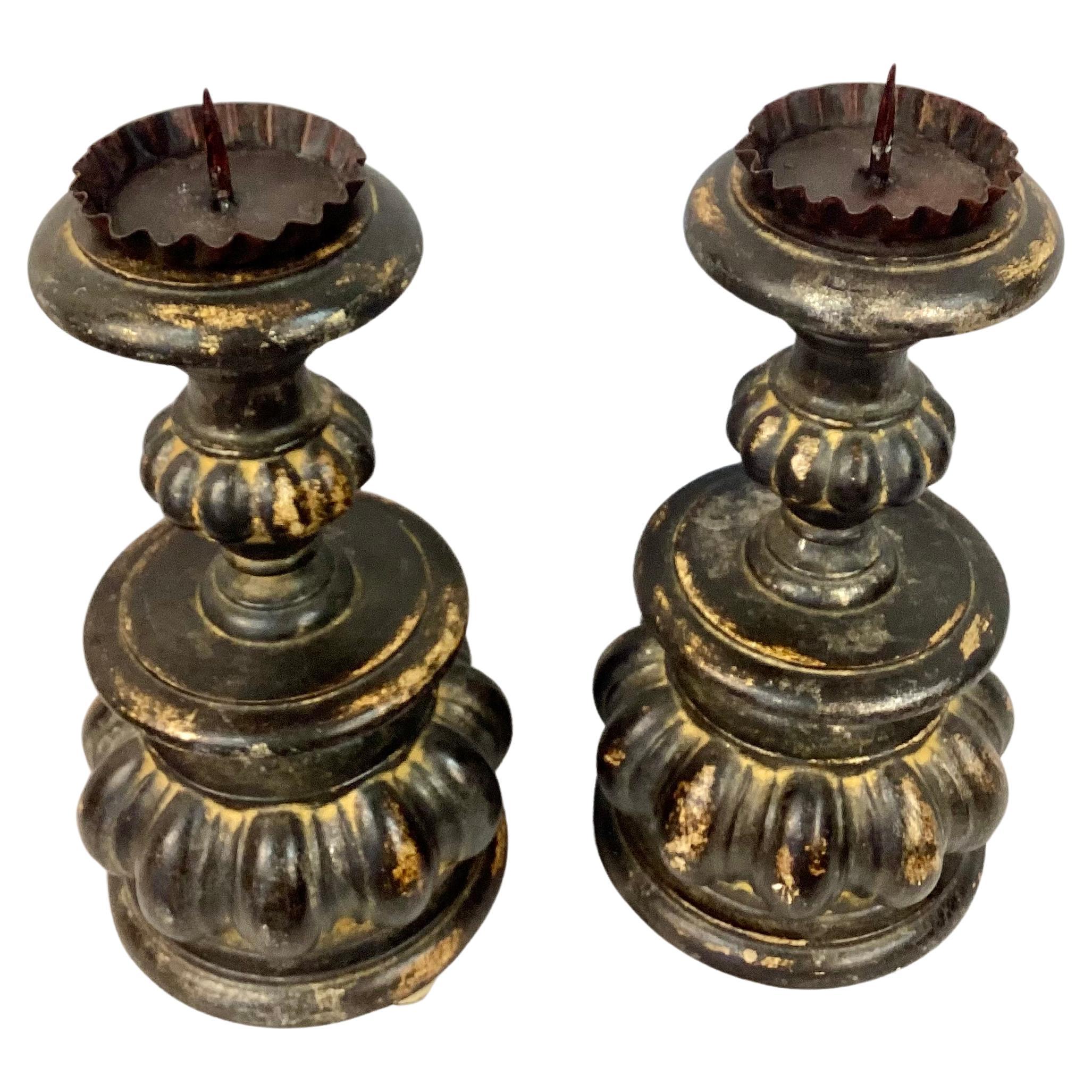 Very nice Pair of 19th Century Italian pillar candleholders. Features beautiful carved bulbous and curved wooden design. Round base. Nice black and tan patina. Wonderful form. 