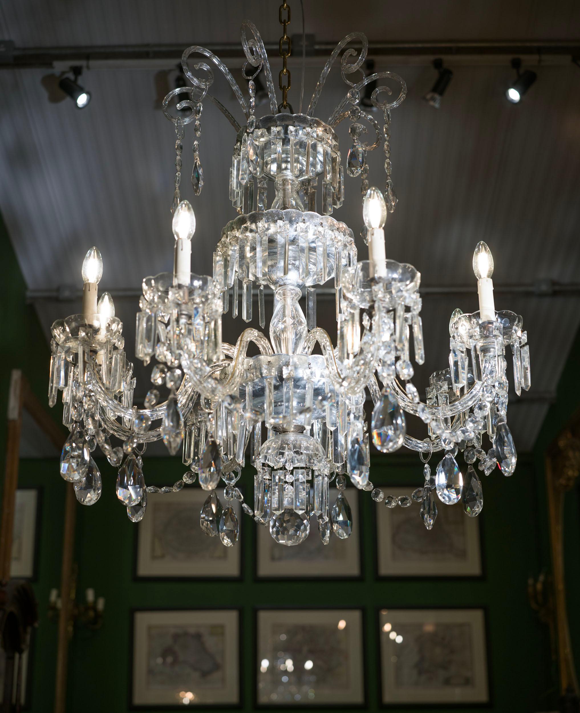 A pair of very fine and large nineteenth-century Northern Italian crystal chandeliers. The pair of eight branch chandeliers have elegant central stems mounted with silvered scalloped bowls which are hung with crisply cut prism drops, from which