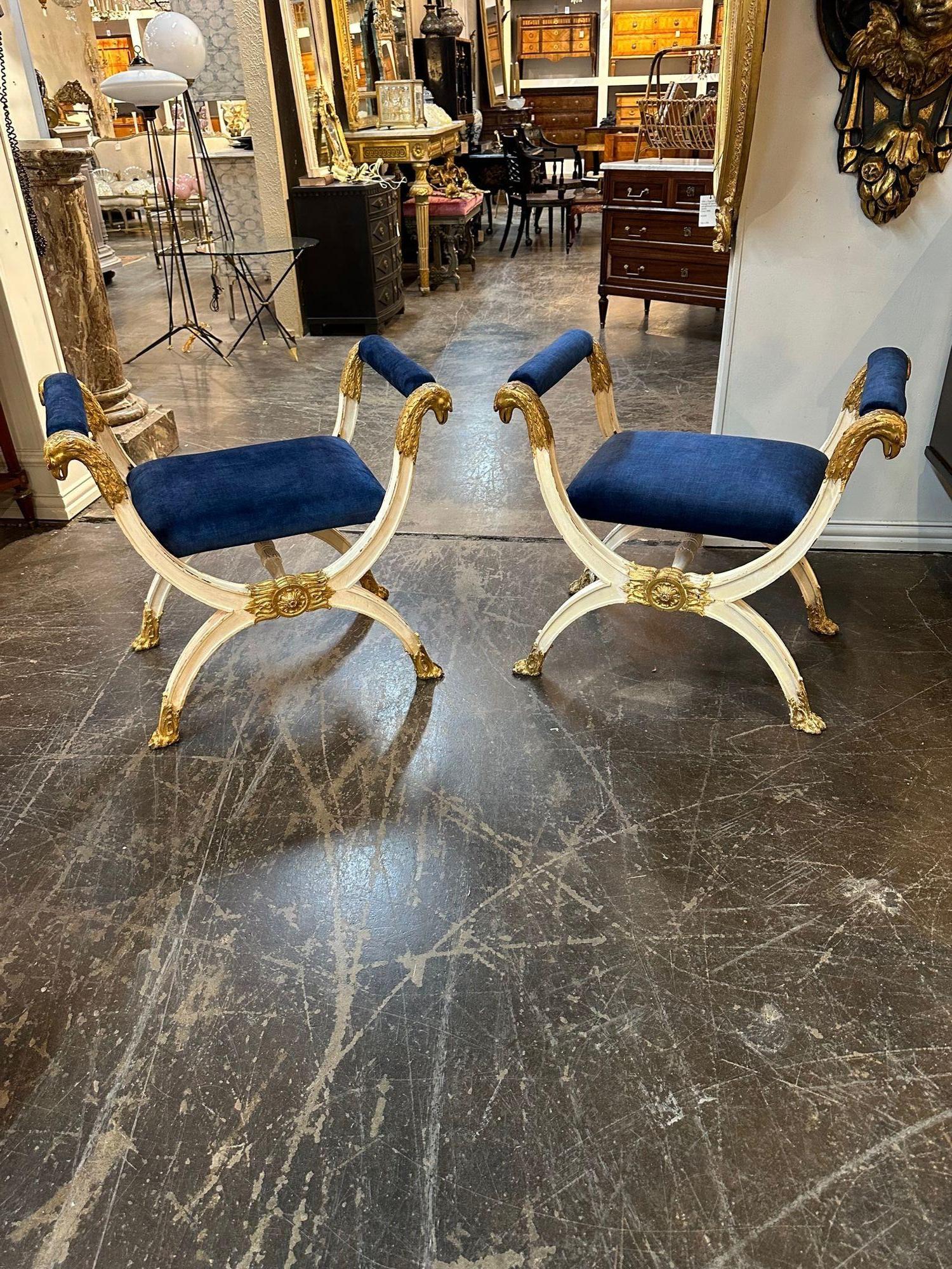 Handsome pair of 19th century Italian Empire style carved and parcel gilt benches. Nice carvings and beautiful royal blue upholstery. Very stylish!