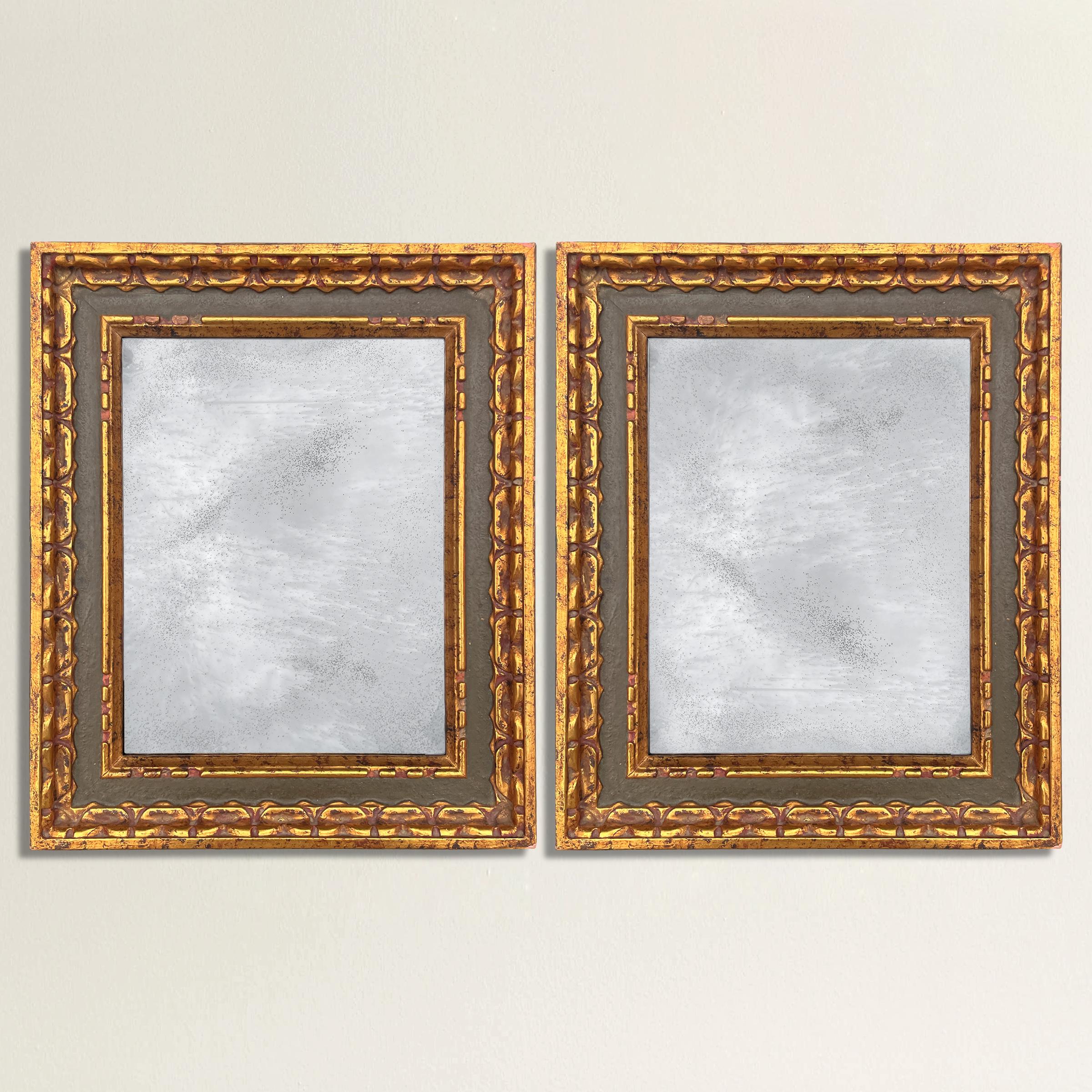 An incredible pair of 19th century Italian carved wood frames with water-gilt highlights, museum olive paint, and the most beautiful wavy silvered and antiqued restoration glass mirrors ever! The perfect pair of mirror to hang over a console table,
