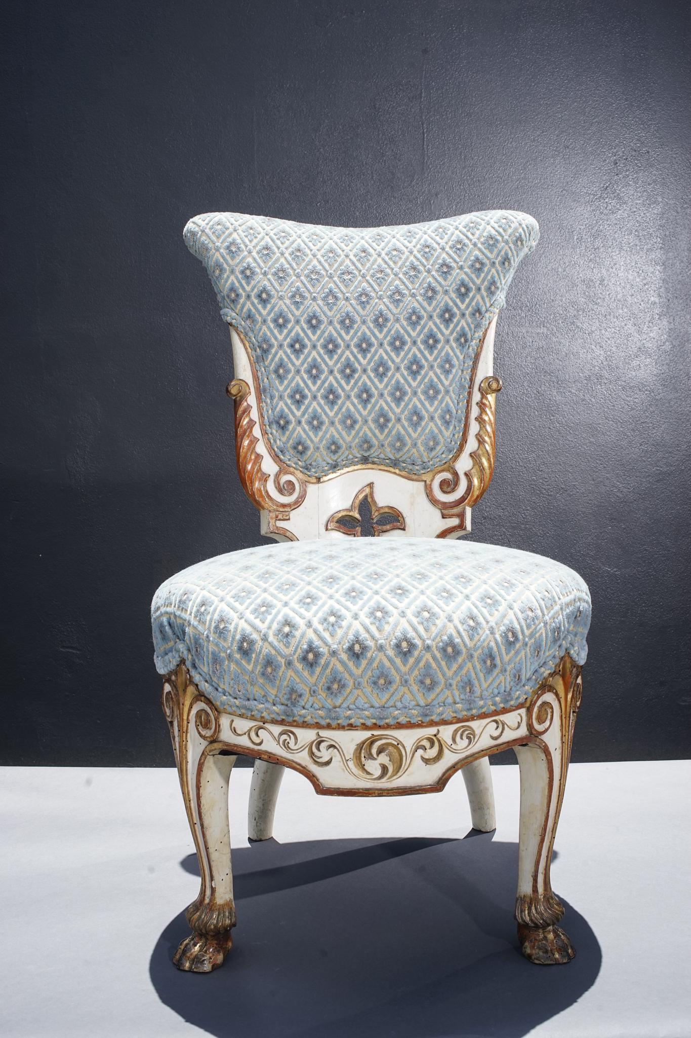 Pair of 19th century Italian giltwood and painted side chairs. Finely carved details with paw feet.