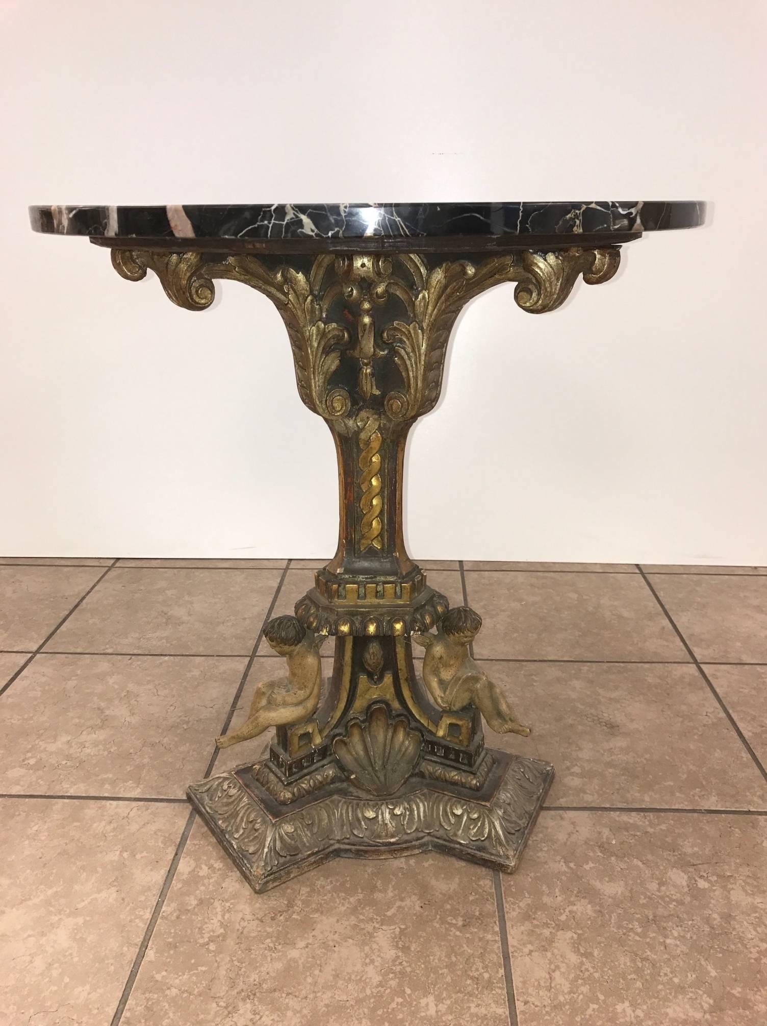 Pair of 19th century Italian giltwood marble-top pedestal tables. Has carved wood base with cherubs.