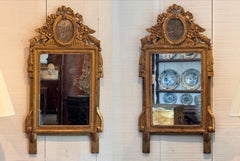 Pareja de espejos italianos de madera dorada del siglo XIX