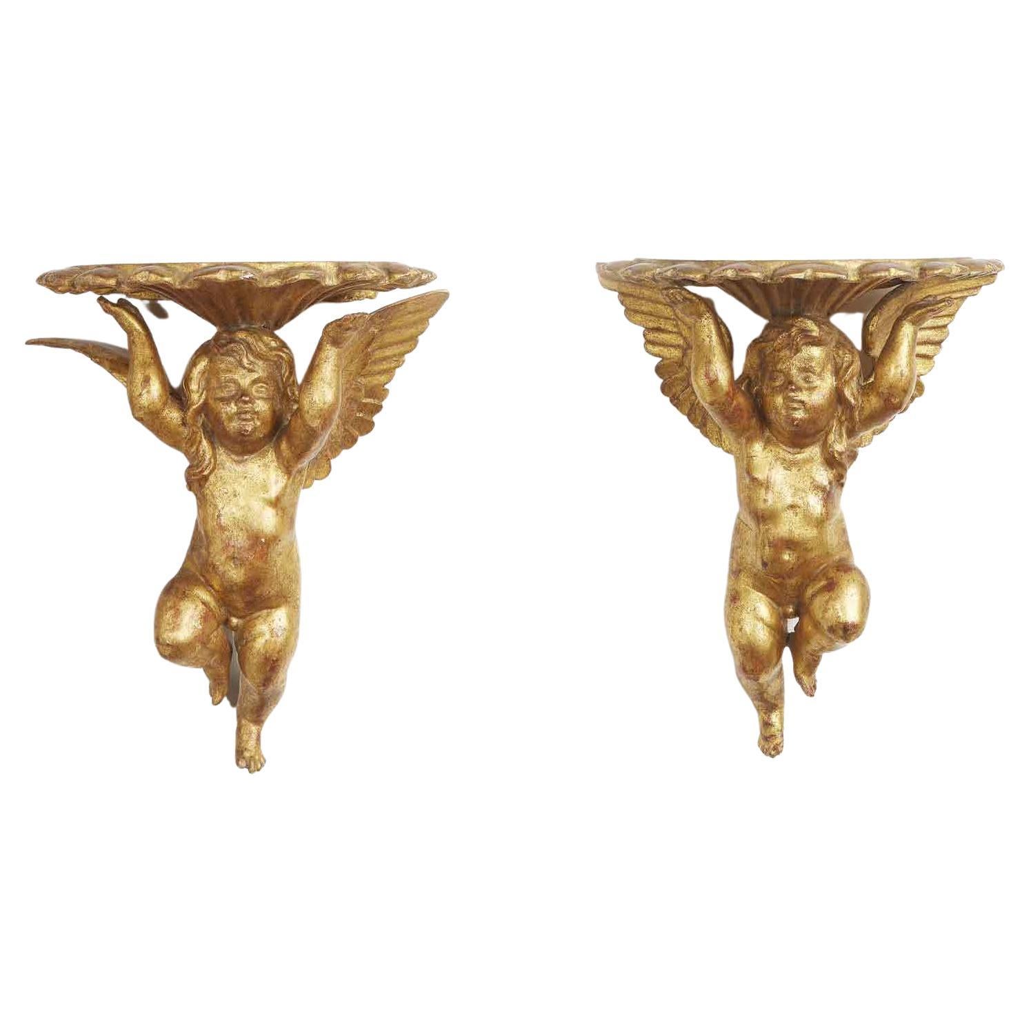 A charming pair of Italian winged putti wall brackets, exquisitely carved and gilded, with shell form tops coming from a Milanese private collection, of Italian origin.

Good age related condition.

Under existing legislation, any artwork in