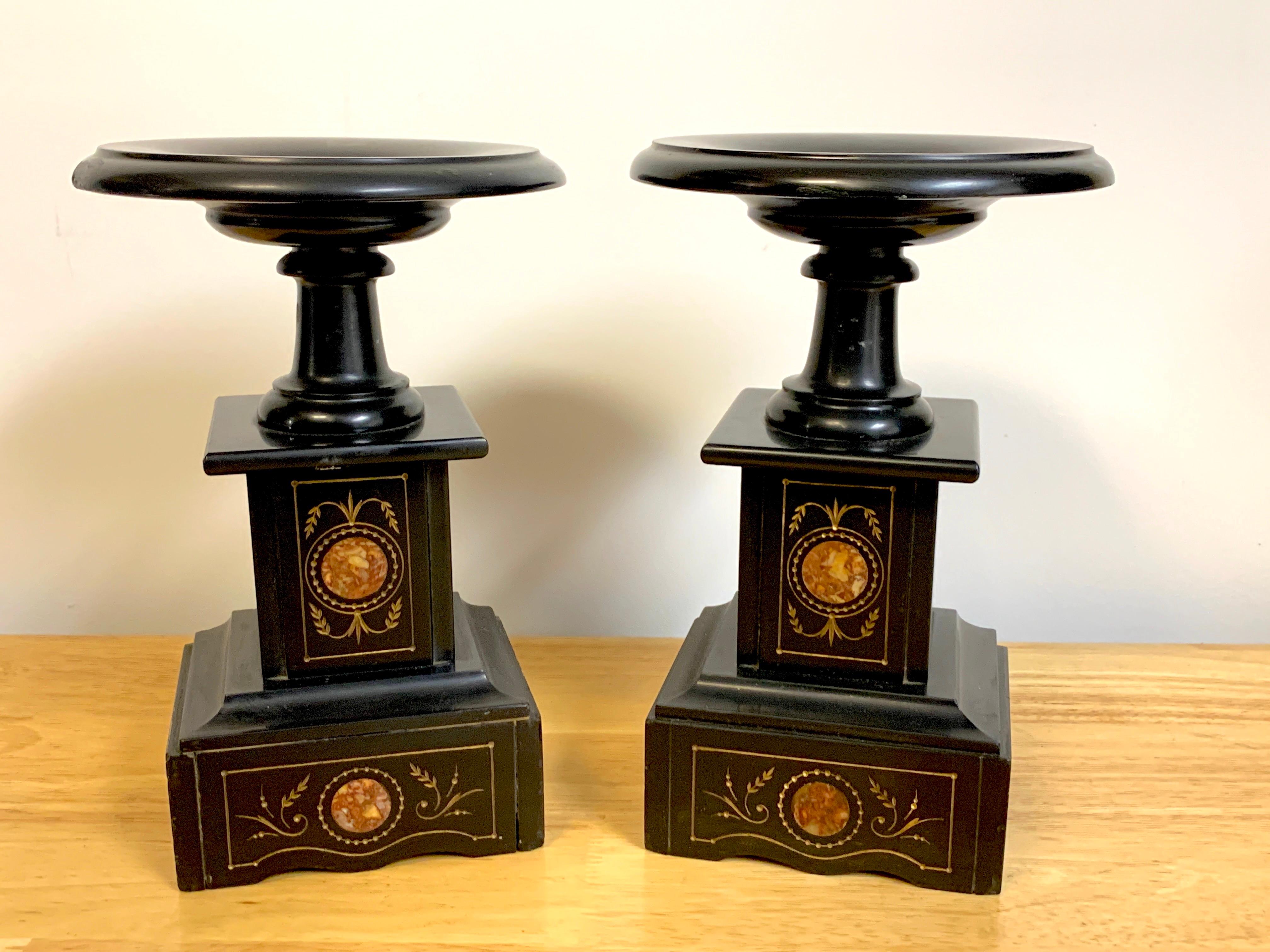 Pair of 19th century Italian Grand Tour inlaid black marble Tazza, each one of typical form with a 6-Inch diameter roundel, raised on an inlaid rose colored marble and gilt incised decoration pedestal base.
The 'dish' is 6-Inches in diameter, the