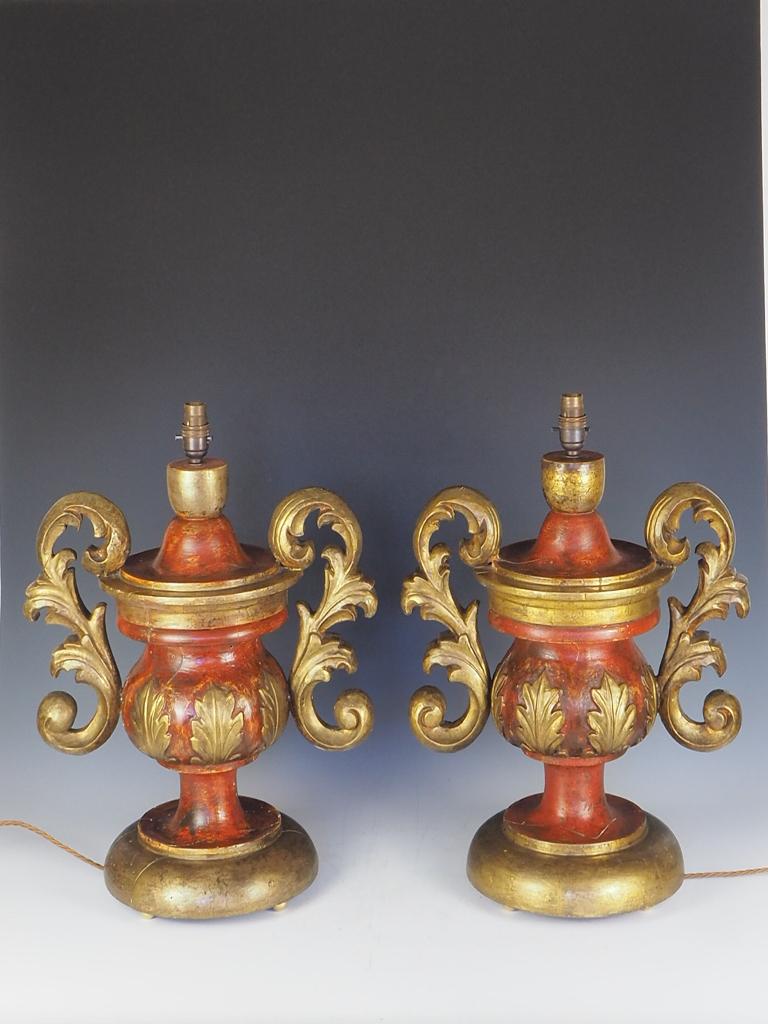 A Pair of 19th Century Italian Hand Carved and Painted Table Lamps

Large and imposing oversized Neo Classical urns with a rich, patinated, hand painted finish over gesso with gilt leaf motif, hand carved relief decoration attached to acanthus
