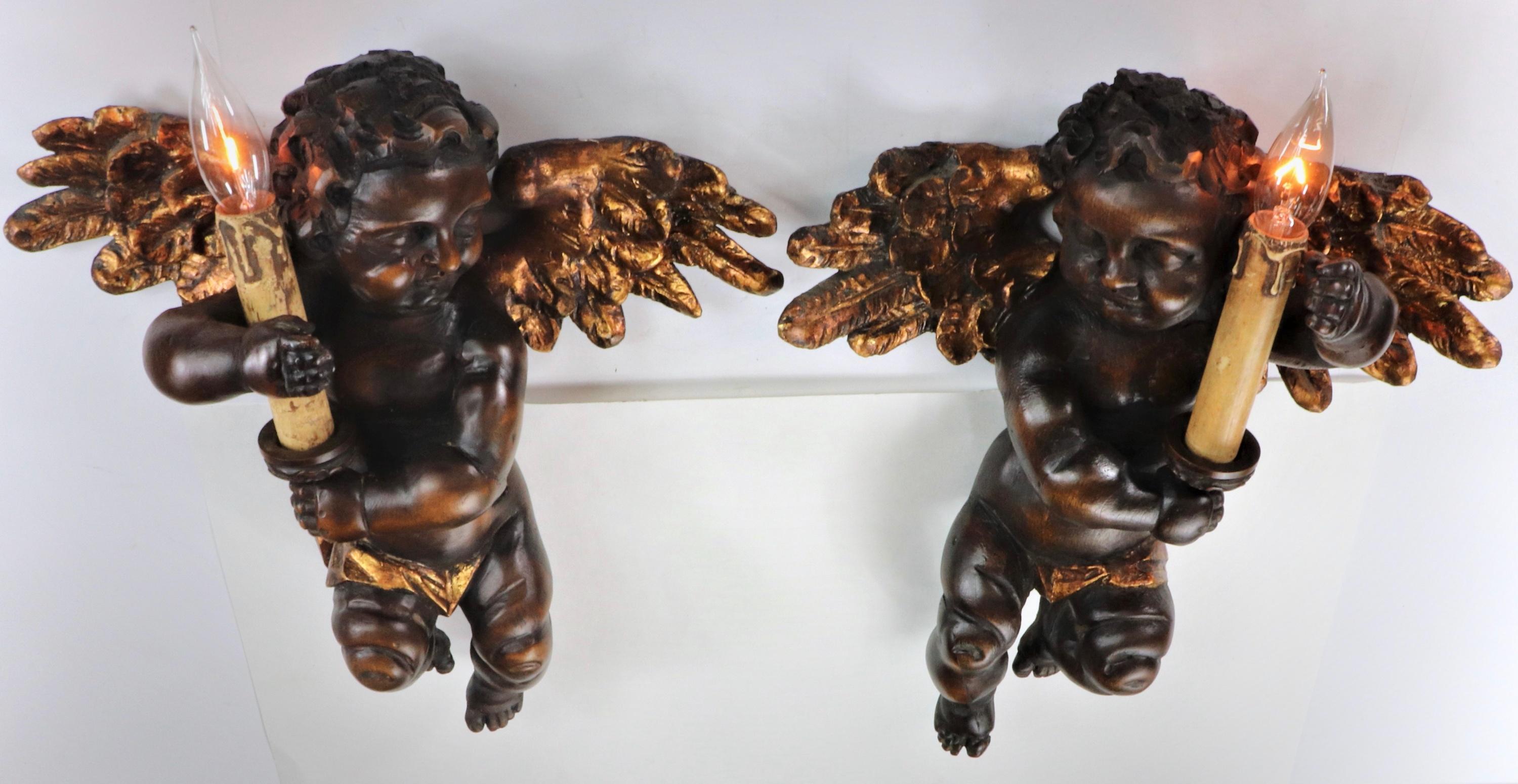 These excellently hand-carved wooden 19th Century Italian angel cherub sconces were done in the traditional Renaissance style. During the Renaissance period, cherub and angel figural carvings were quite popular. The Italian artist, Raphael created