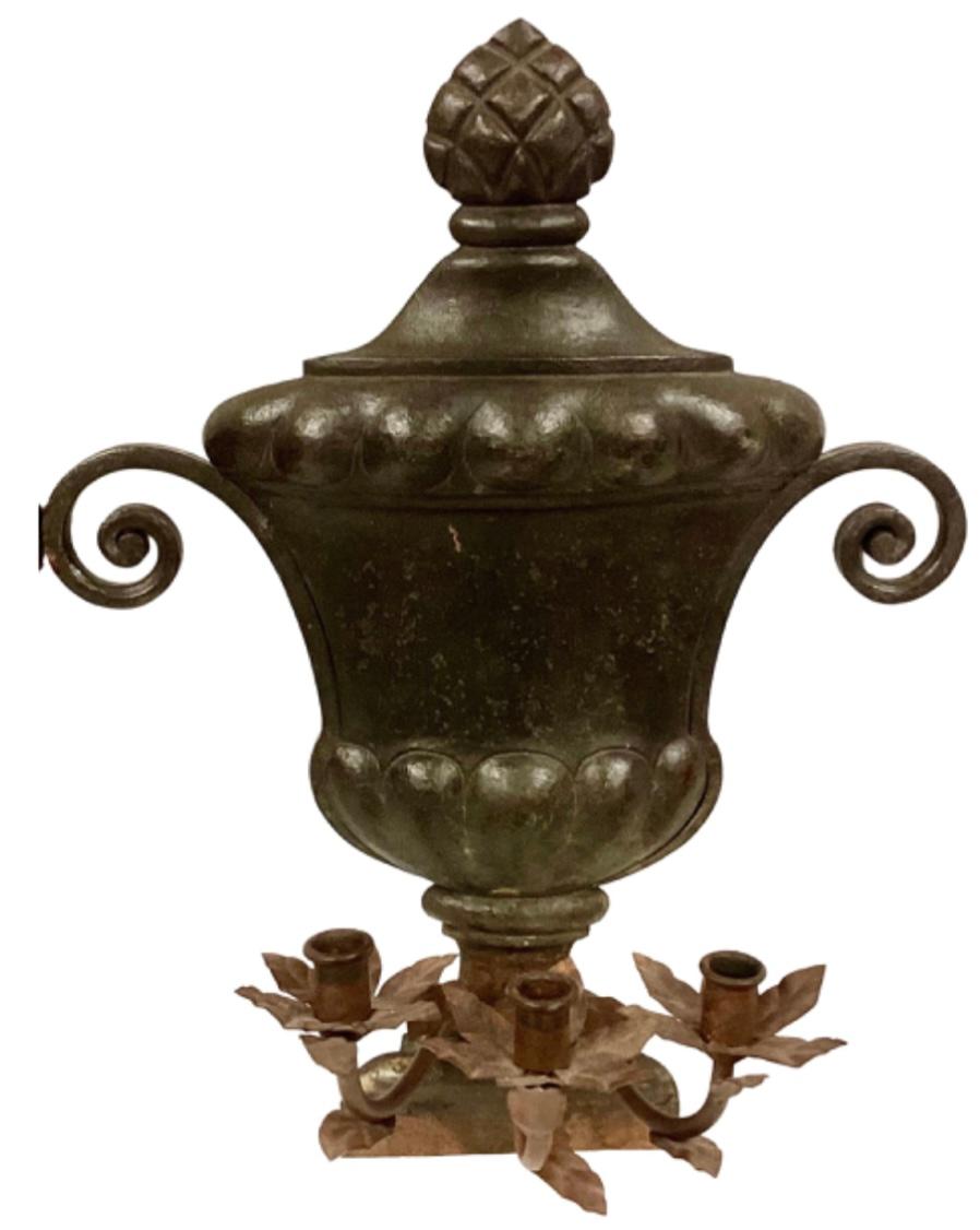 Pair of 19th century Italian iron wall sconces, heavy in weight. Ornate urn shaped with three armed candelabra, each candle holder surrounded by leaves.