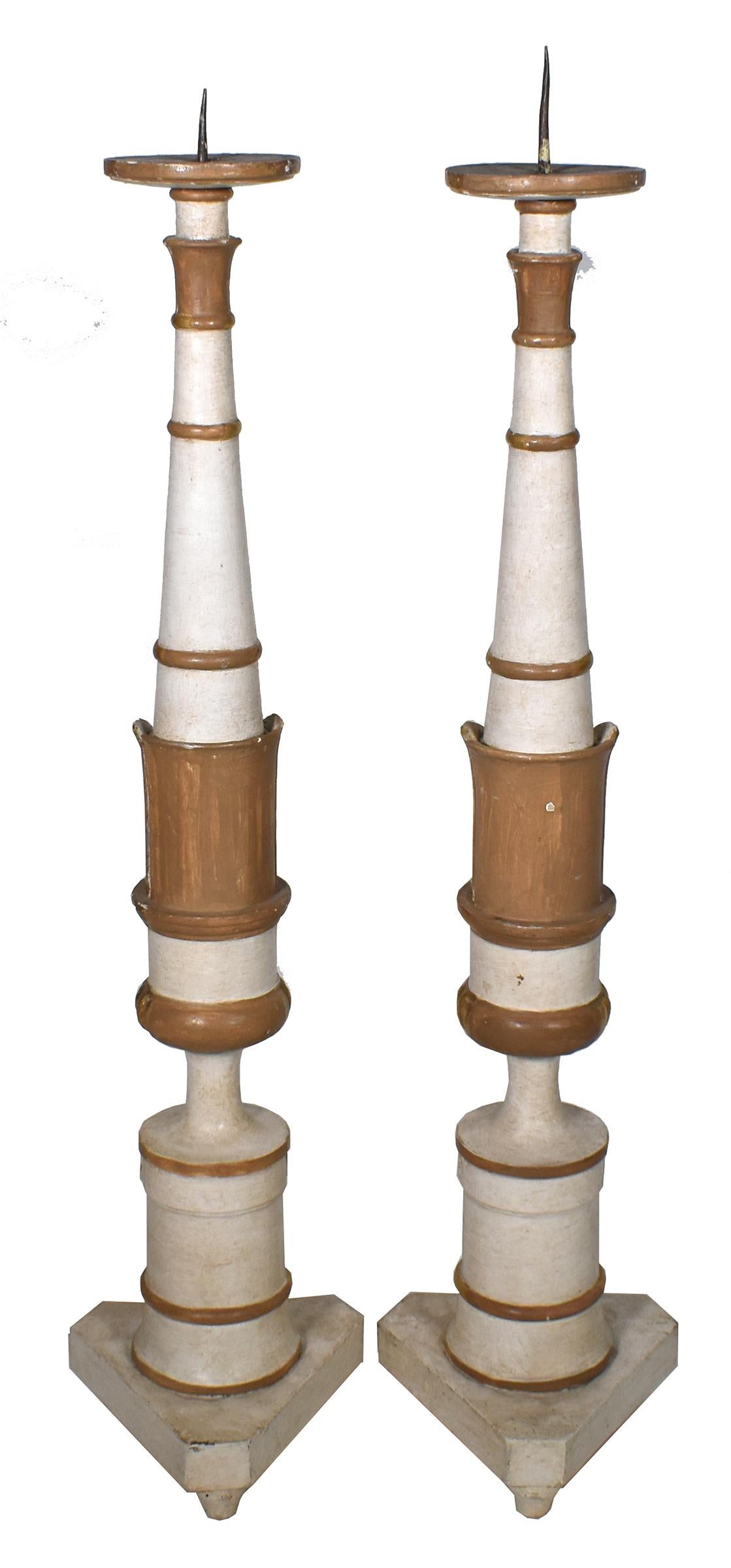 19th Century Italian Neoclassical gilded carving and off-white patina make these tall candlesticks an appealing accessory. 

 