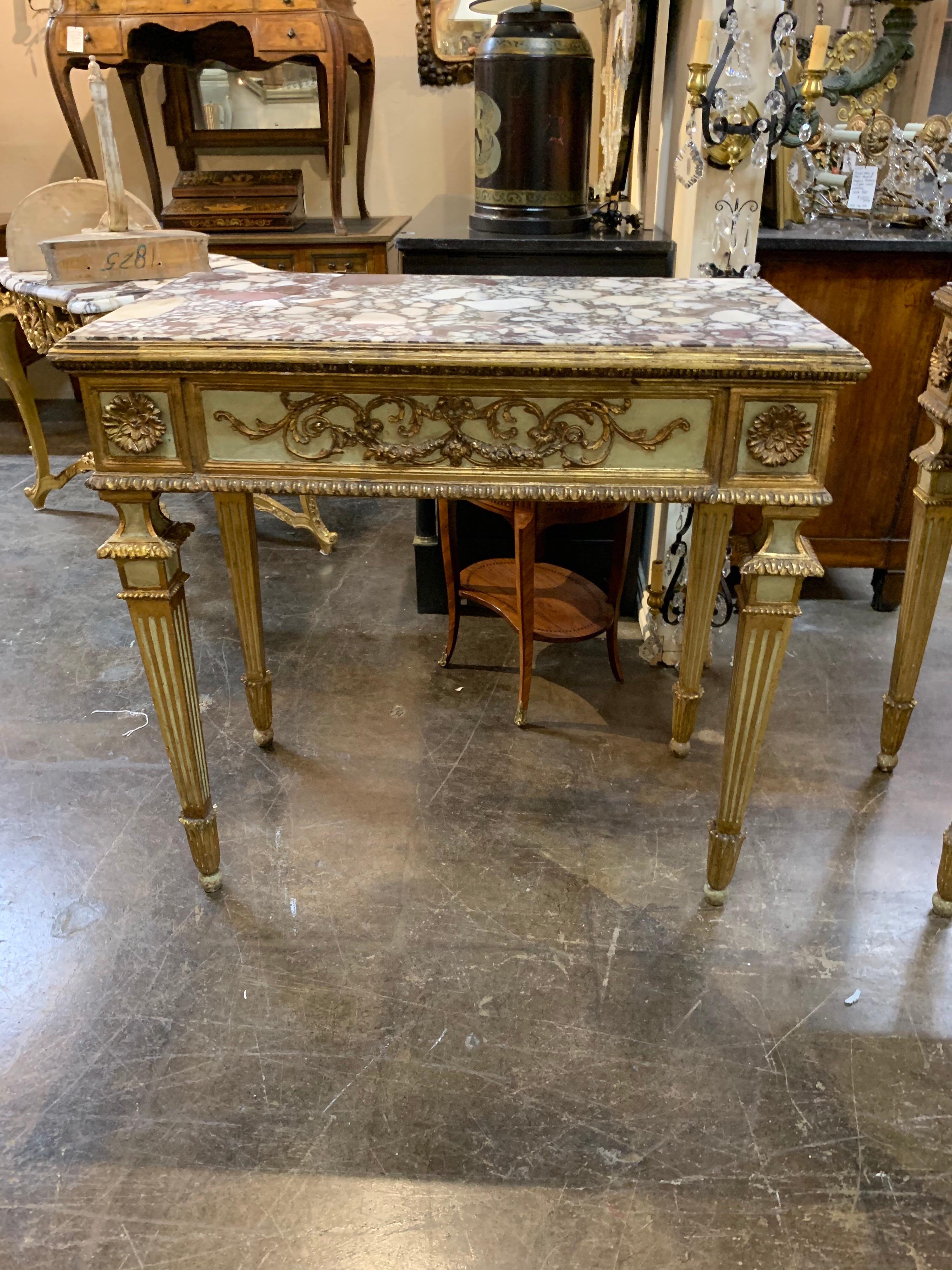 Fabulous pair of Italian neoclassical carved and painted consoles with beautiful Breccia Violetta marble. Outstanding carving and gilt on these. Absolutely stunning!