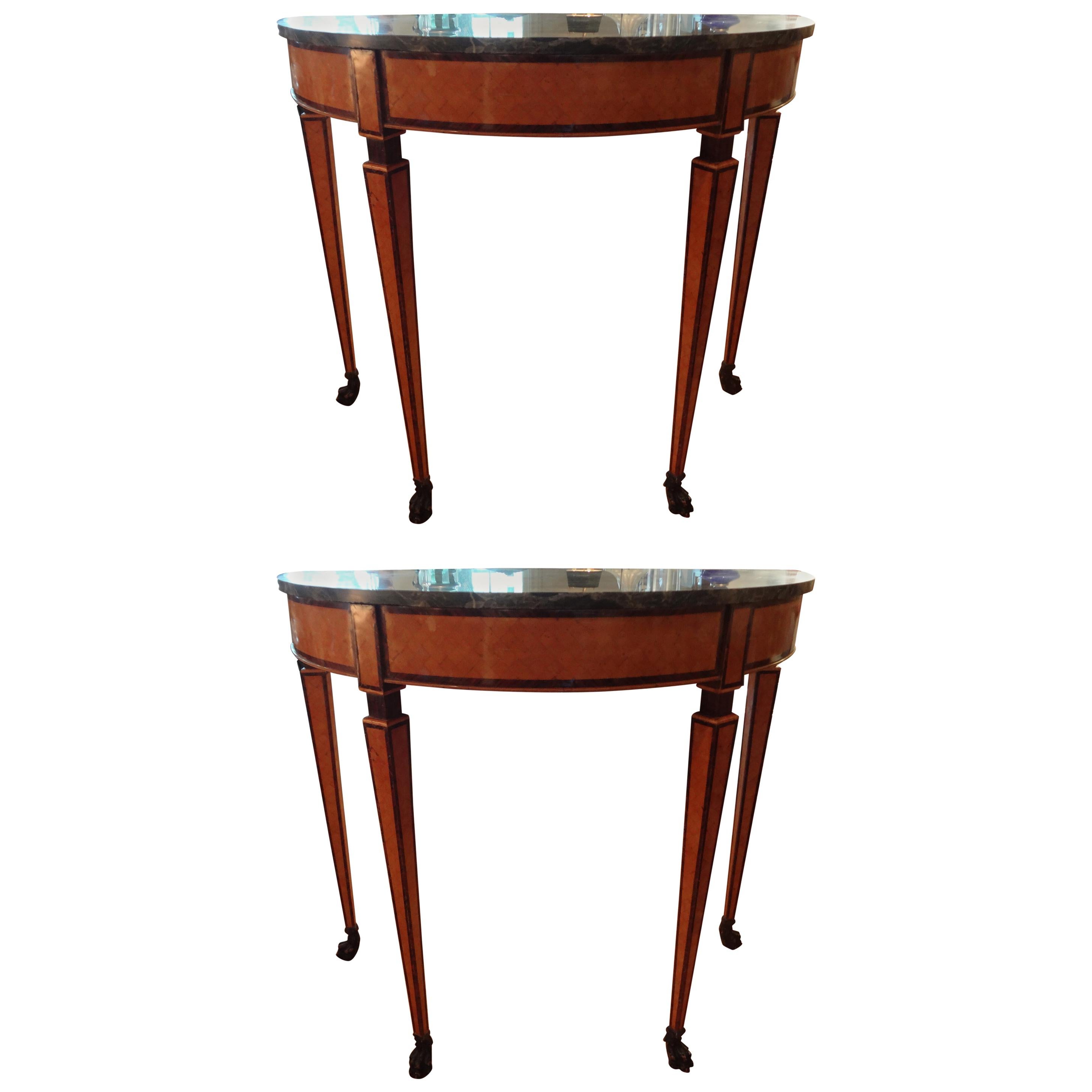 Matching pair of 19th century Italian Neoclassical style parquetry console tables. This pair of Antique Italian demilune tables have a beautiful fruitwood geometric inlaid design with paw feet and marble tops.