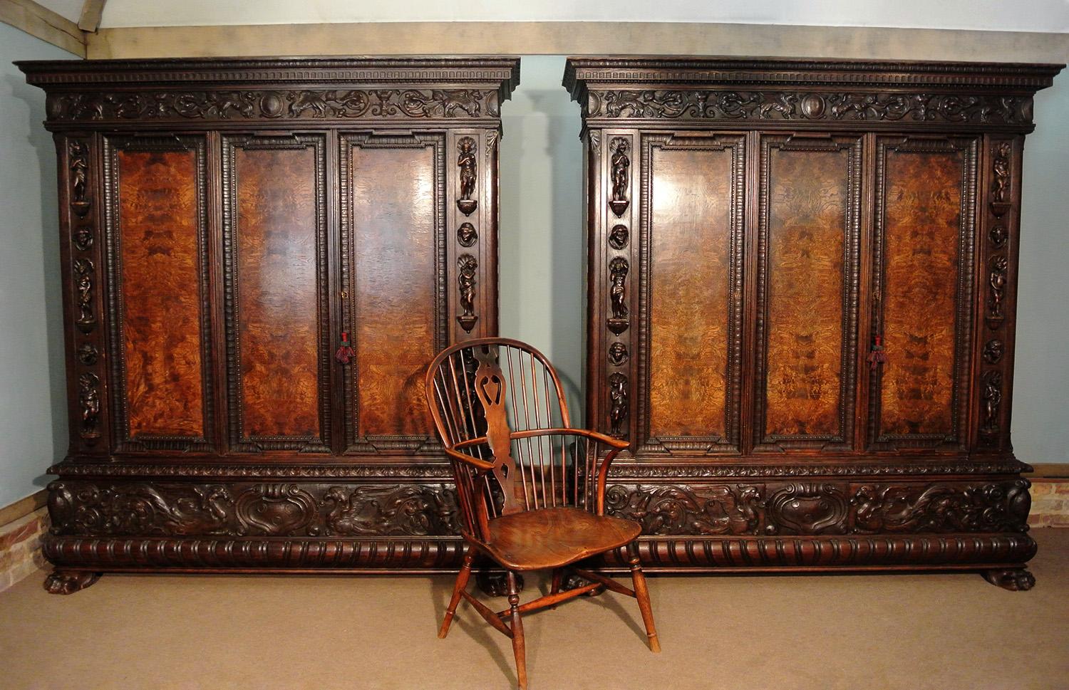 Very fine quality pair of oak and burr walnut Italian armoires, each with three doors which open on strong original pintel hinges. The armoires each have three original and adjustable shelves but are suitable also for rails and the shelves can be