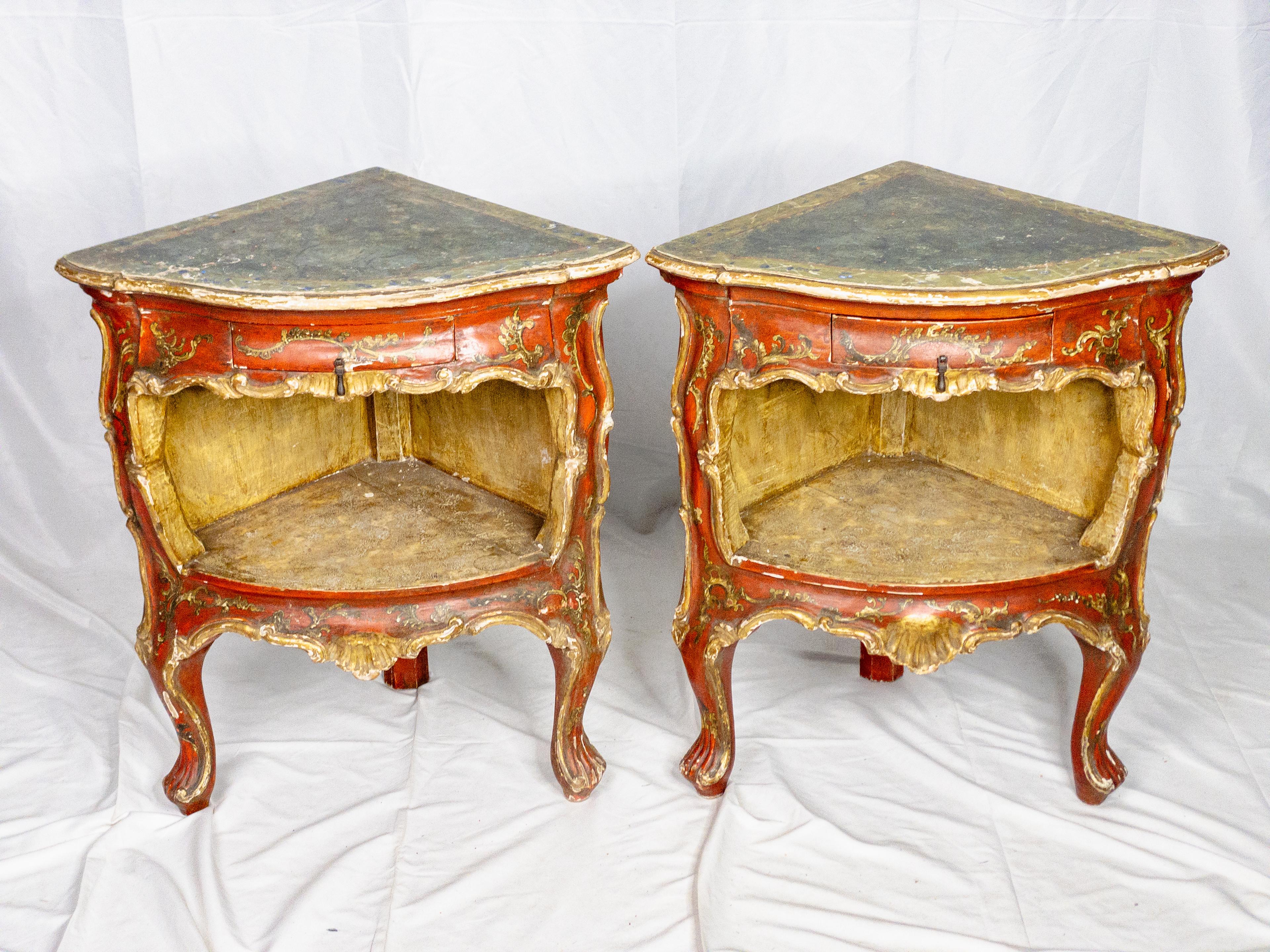 This exquisite pair of 19th-century Italian painted chests showcases exceptional craftsmanship and timeless elegance. The vibrant red hue, adorned with meticulously carved gilt details, exudes opulence and sophistication. The green painted tops add