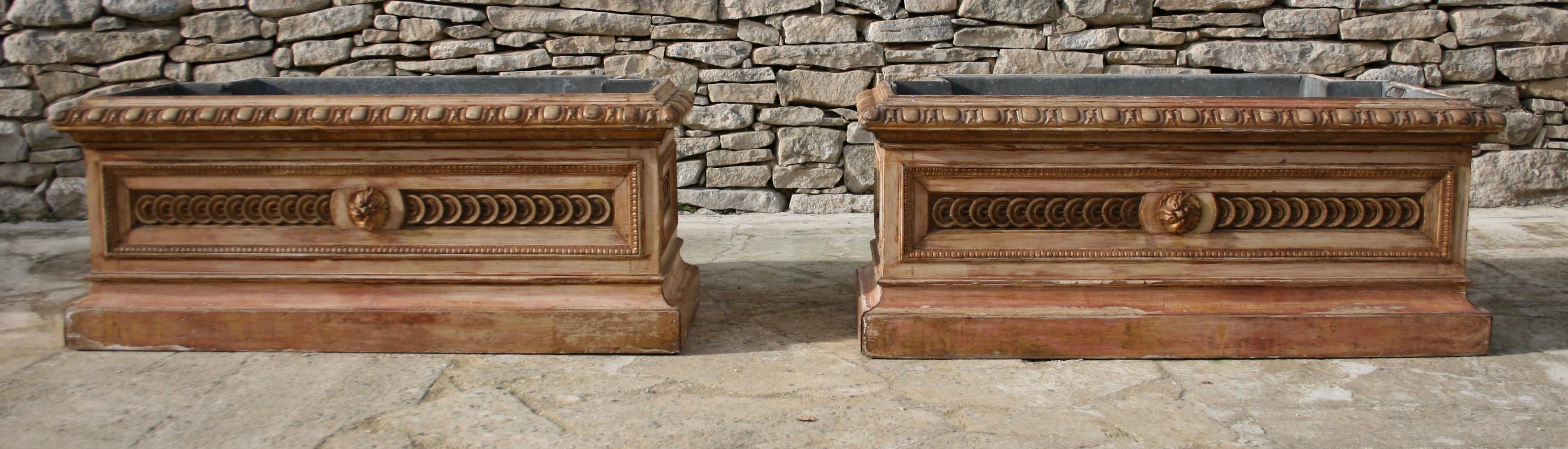 A statement pair of rare and highly decorative late 19th century Italian planters in the Directoire style with original zinc lining and beautiful repeated carved panels to the front and sides.