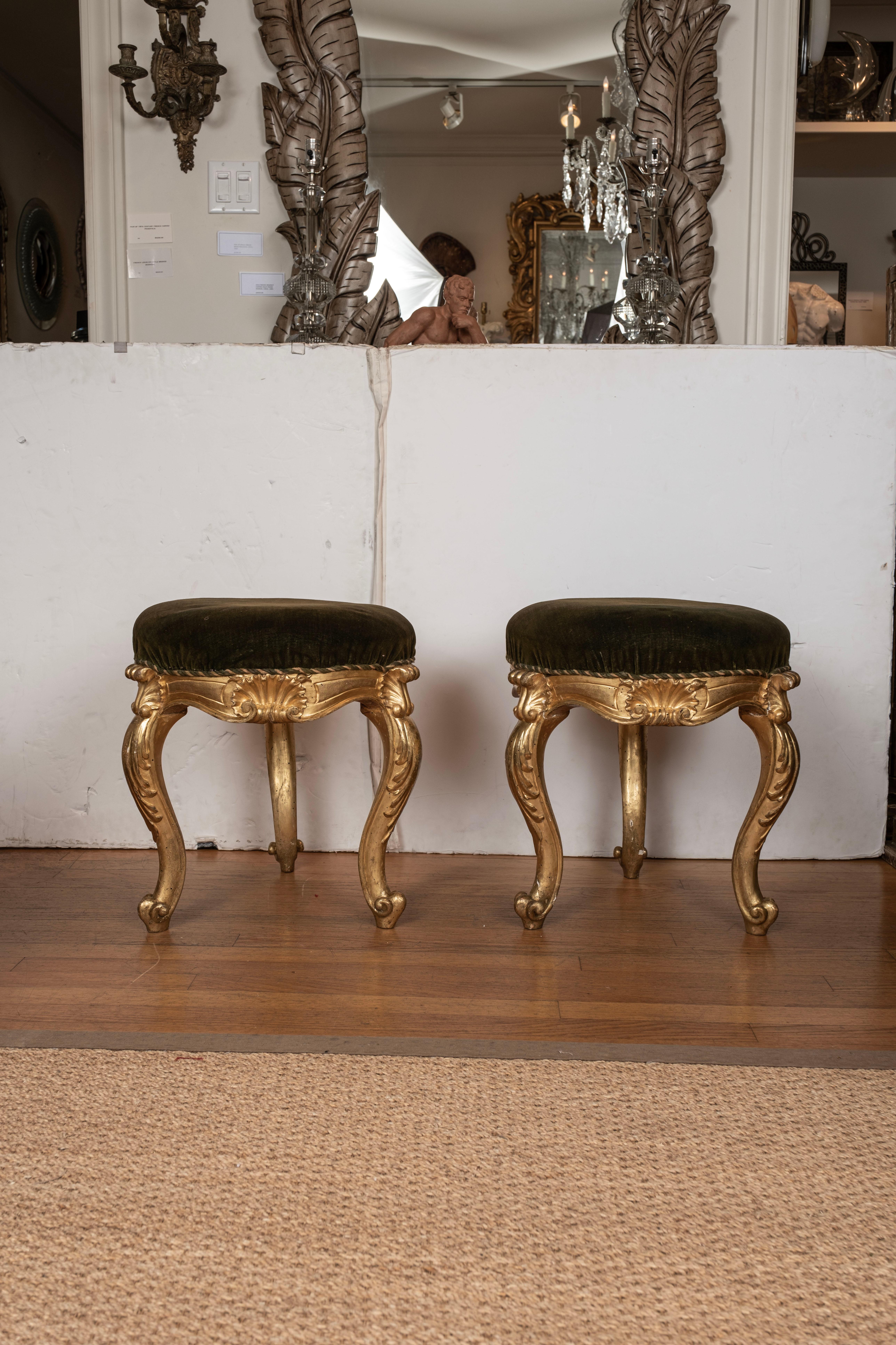 Pair of 19th century Italian Regence style giltwood benches.
These unusual three legged round Italian gilt wood benches, ottomans, poufs, or stools have graceful lines and are a versatile pair ready for the fabric of your choice.
Beautiful patina!