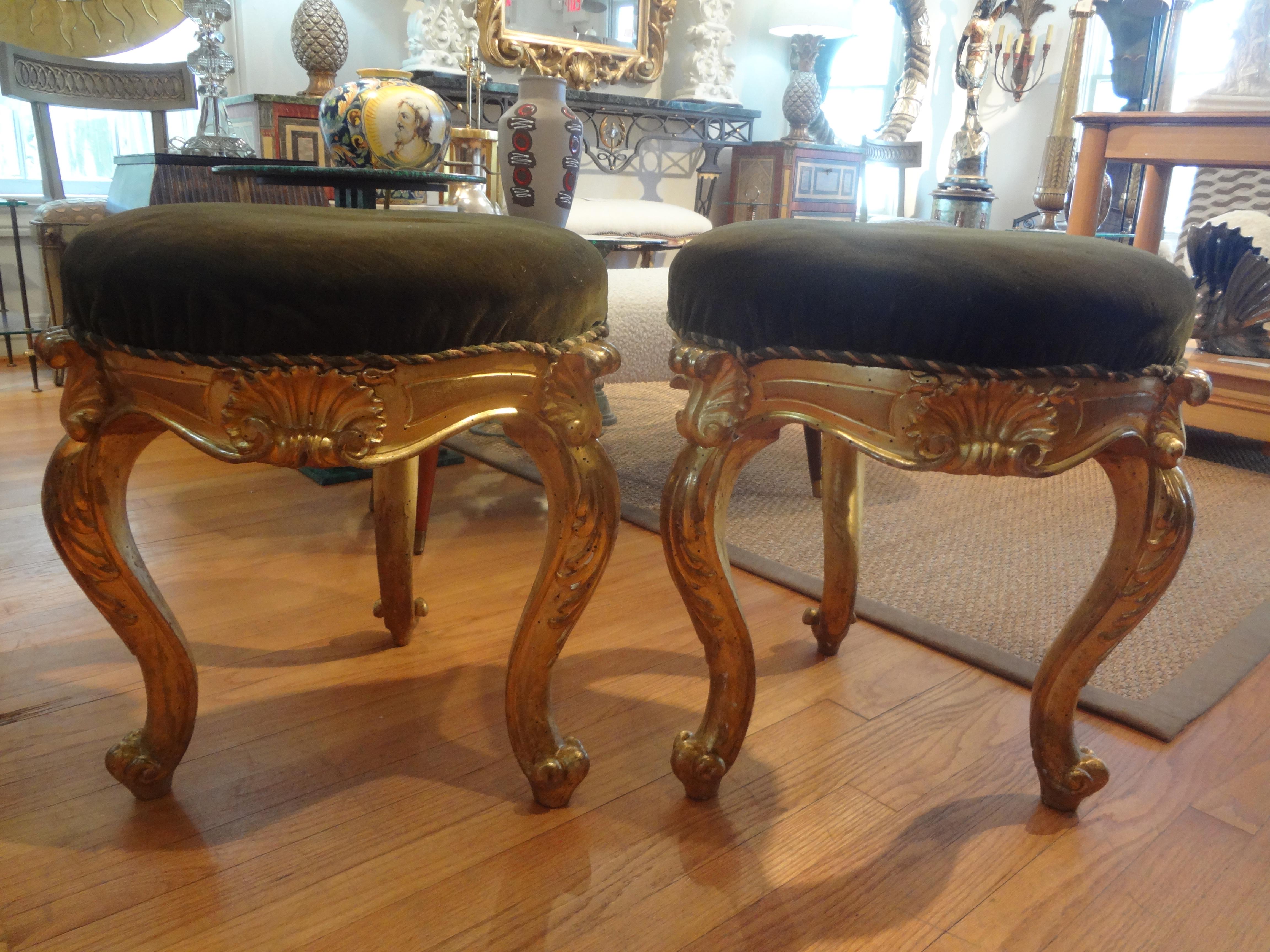 Pair of 19th century Italian Regence style Giltwood ottomans.
We offer a pair of antique Italian Régence style three legged round gilt wood ottomans, poufs, stools or benches with beautifully carved shell detail terminating in cabriole legs.
This