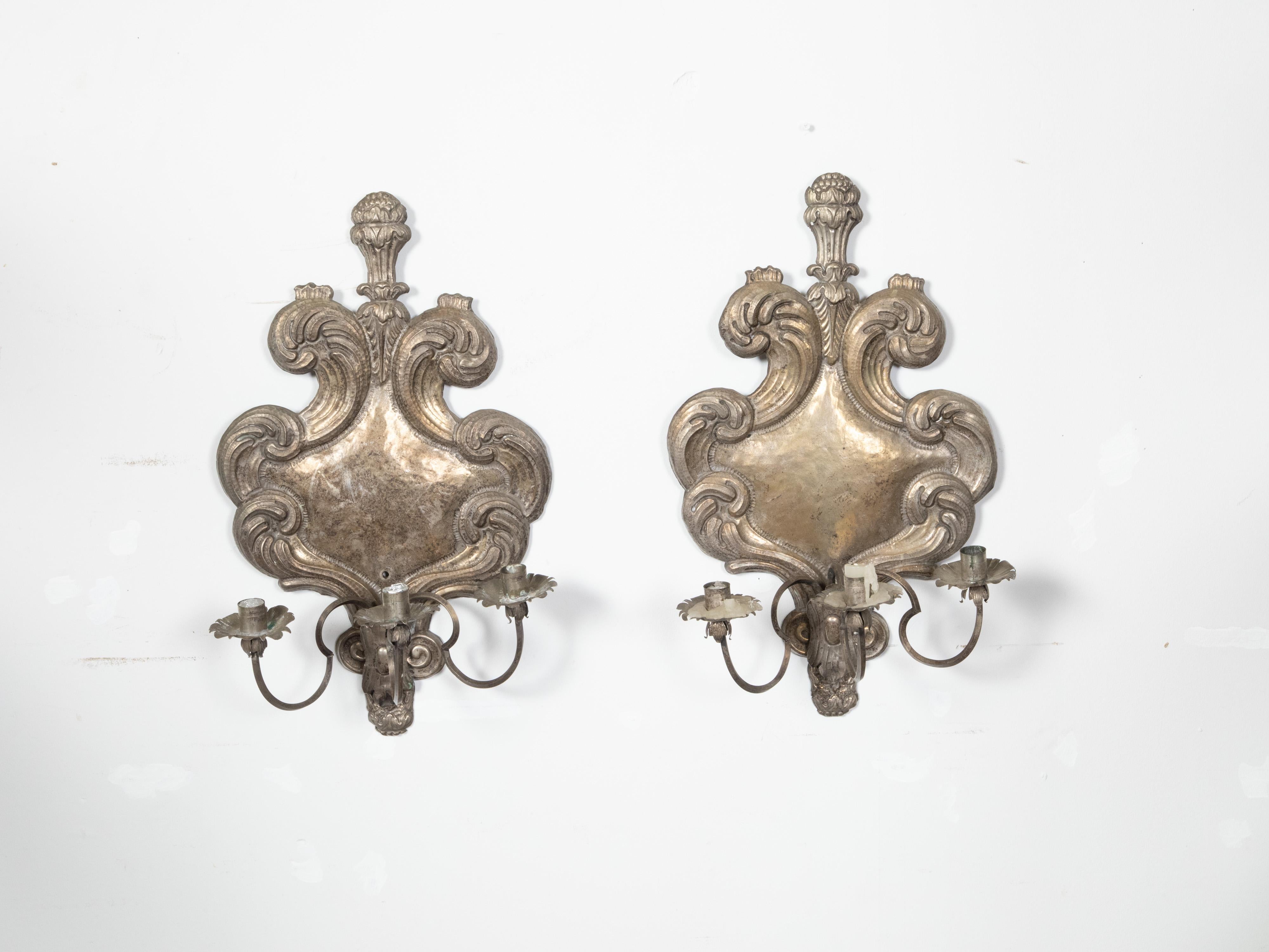 A pair of Italian Rococo style tin candle sconces from the 19th century, with three arms and feather motifs. Created in Italy during the 19th century, each of this pair of tin sconces captures our attention with its graceful arrangement of feathers