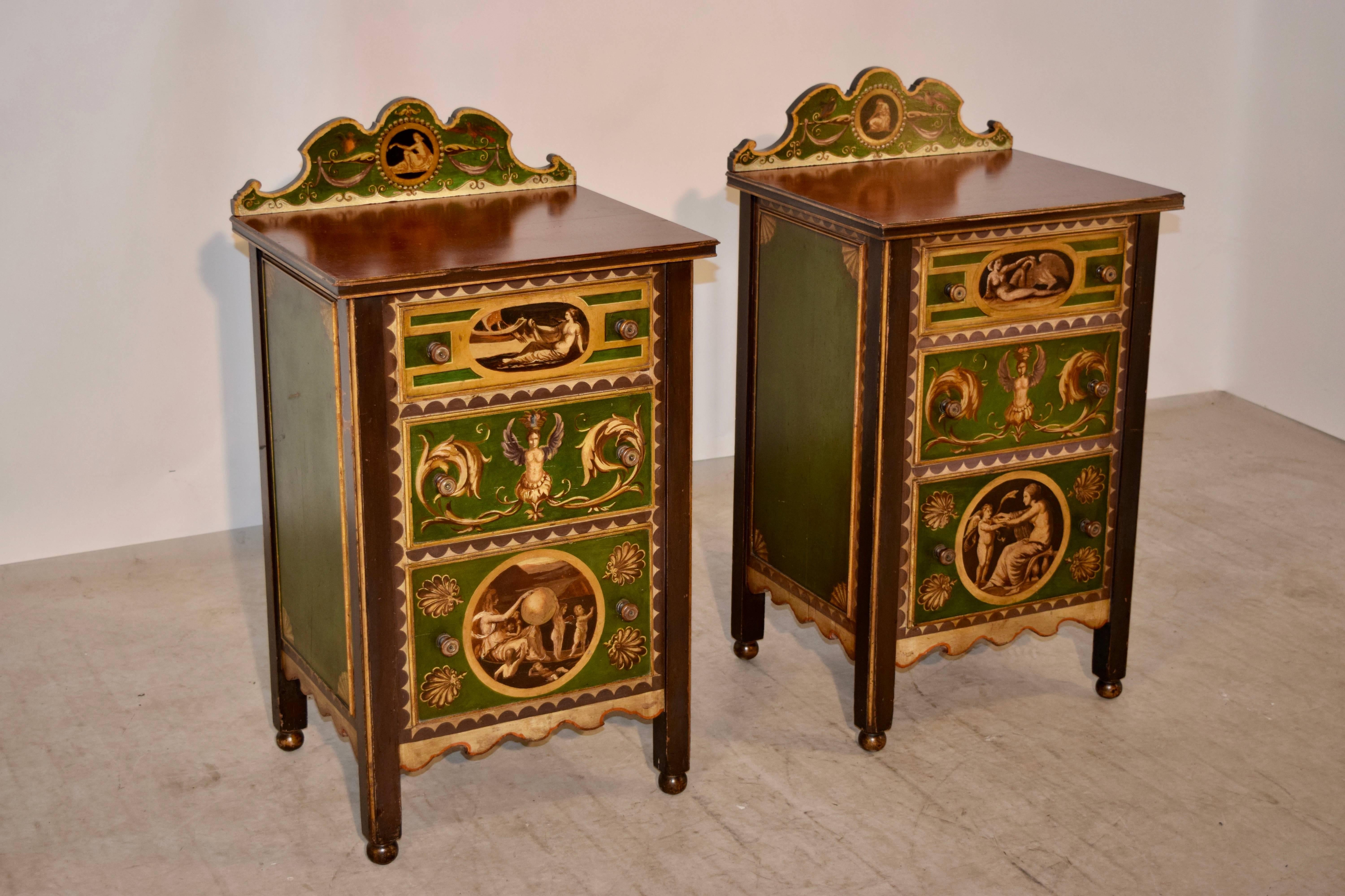Pair of exquisitely hand-painted side tables from Italy. They have wonderfully painted cabinets, with three drawers in the front and hand panelled sides. The backsplashes are shaped and hand-painted as well to compliment the drawer fronts and the