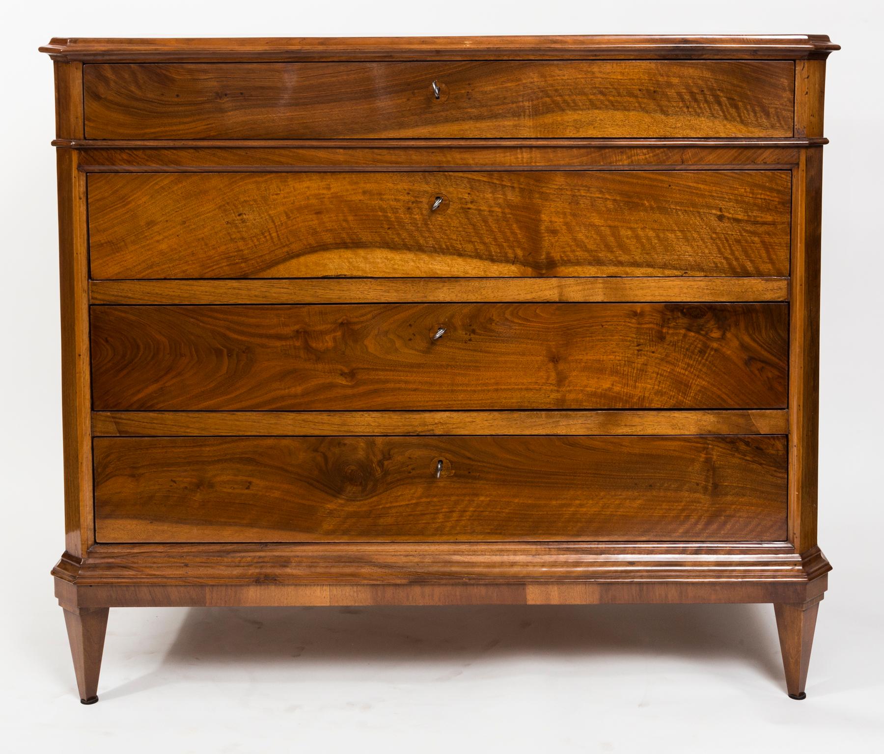A very lovely pair of late 19th century taller chests comprised of five drawers with chamfered front edges finishing to straight tapered legs. Made of  solid walnut  in very warm honey walnut color.

A working key is provided for each drawer.