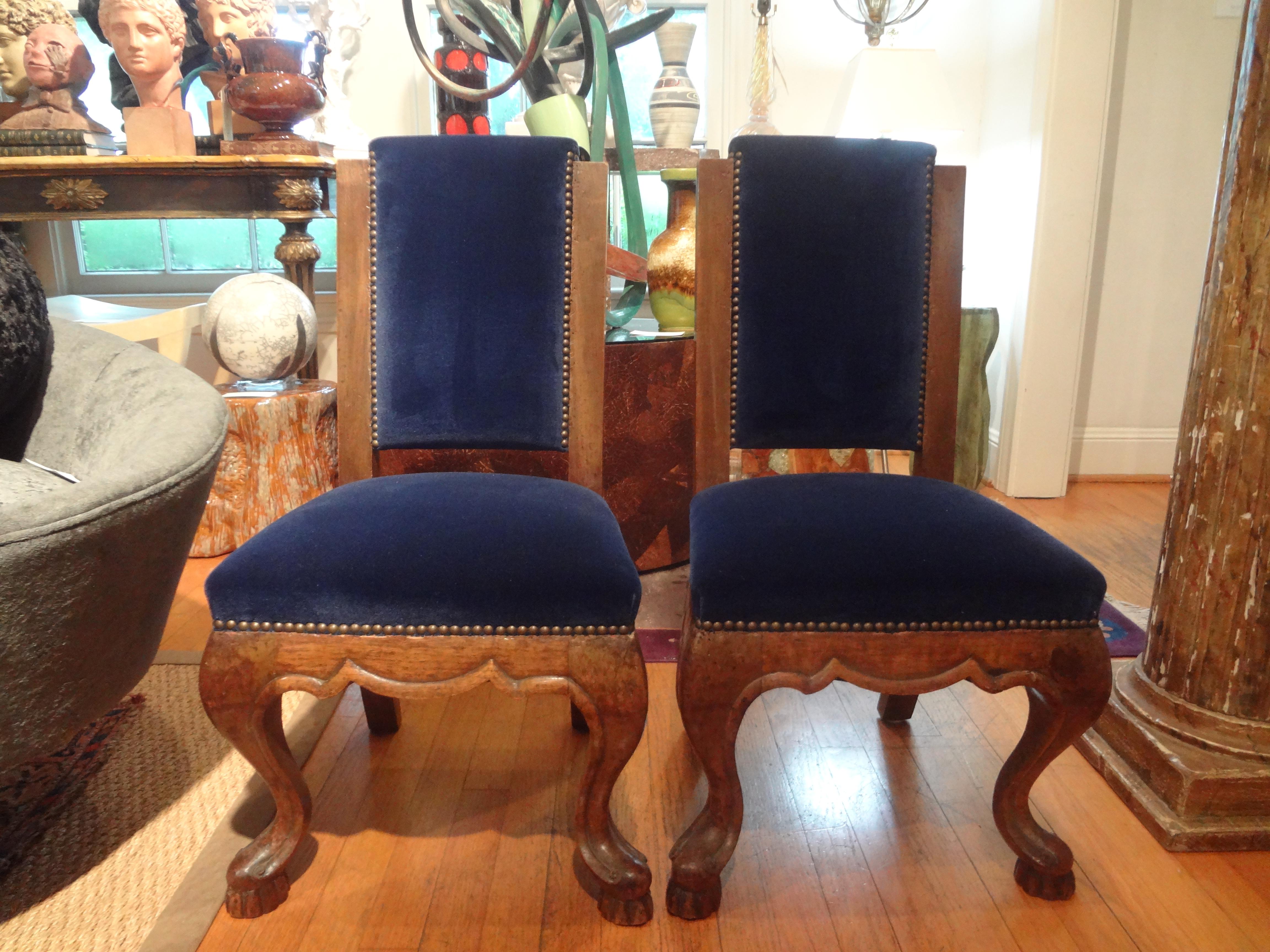 Pair of 19th century Italian walnut children's chairs.
Fabulous pair of 19th century Italian walnut children's chairs from Tuscany. This rare pair has gorgeous lines and has been professionally upholstered in dark blue mohair with brass nail head