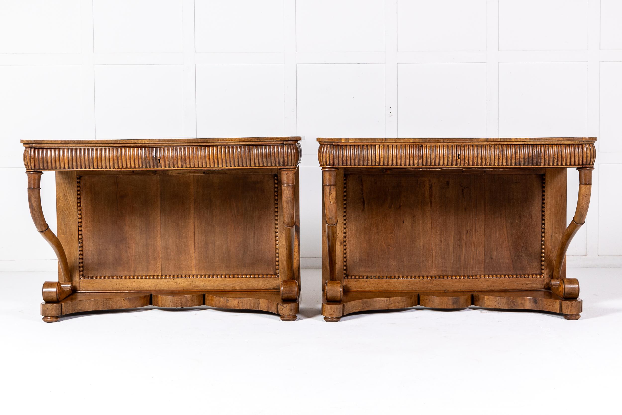 An Interesting and Good Sized Pair of 19th Century Italian Walnut Console Tables.

These fine tables have panelled backs surrounded by fine beaded mouldings. The rectangular tops have rounded corners and are inlaid in the centre with exceptionally