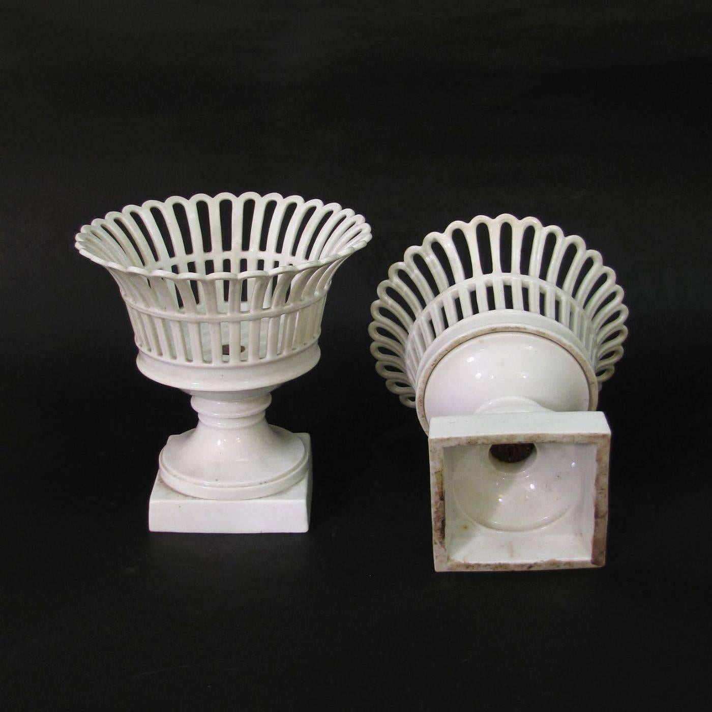 A beautiful pair of fruit baskets in white porcelain.
The square base is surmounted by an elegant perforated bowl or basket.
Italy, late 19th century.

    