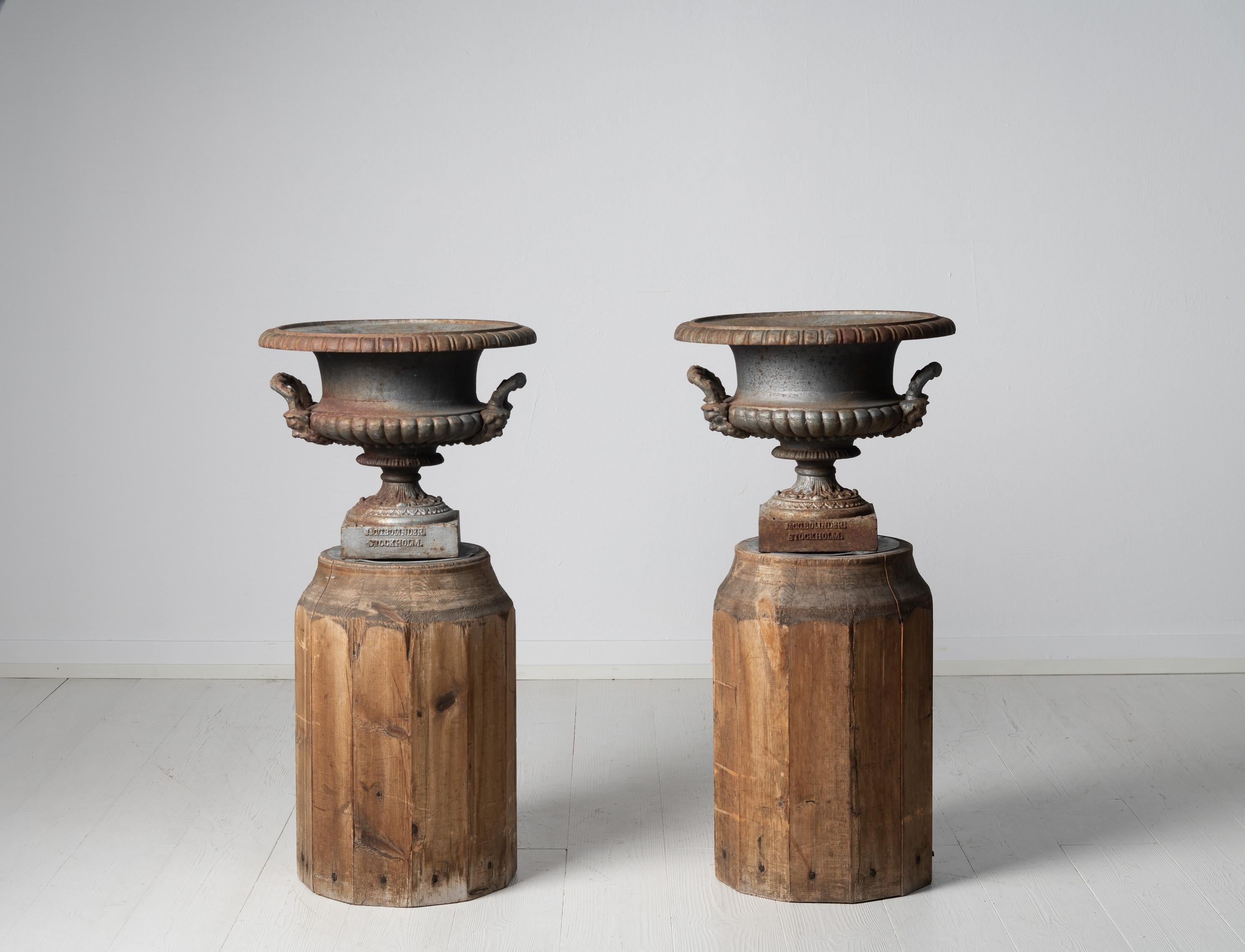 Antique cast iron urns from Sweden made during the late 19th century, around 1870. The garden urns are the classic medicine shape with handles at the sides. Marked “J. & C.G. Bolinder Stockholm” and N:16 on the feet. The urns are in untouched