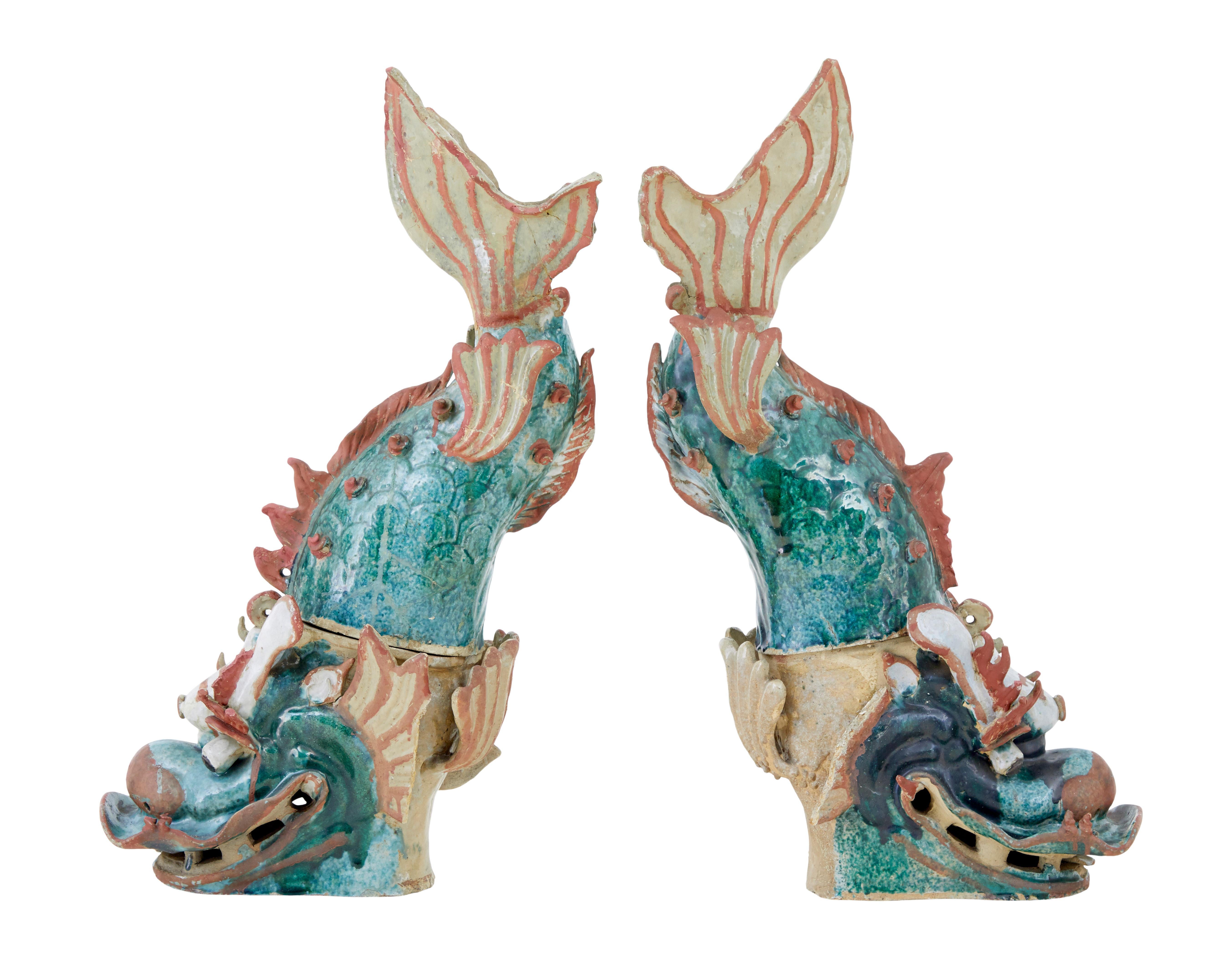 Striking pair of 19th century Shachikoko rood ornaments circa 1880.

These appear to be 'shachikoko' sea monsters still retaining their bold colours, showing the head of a dragon with the body of a carp.

Both are made from 2 sections and would have