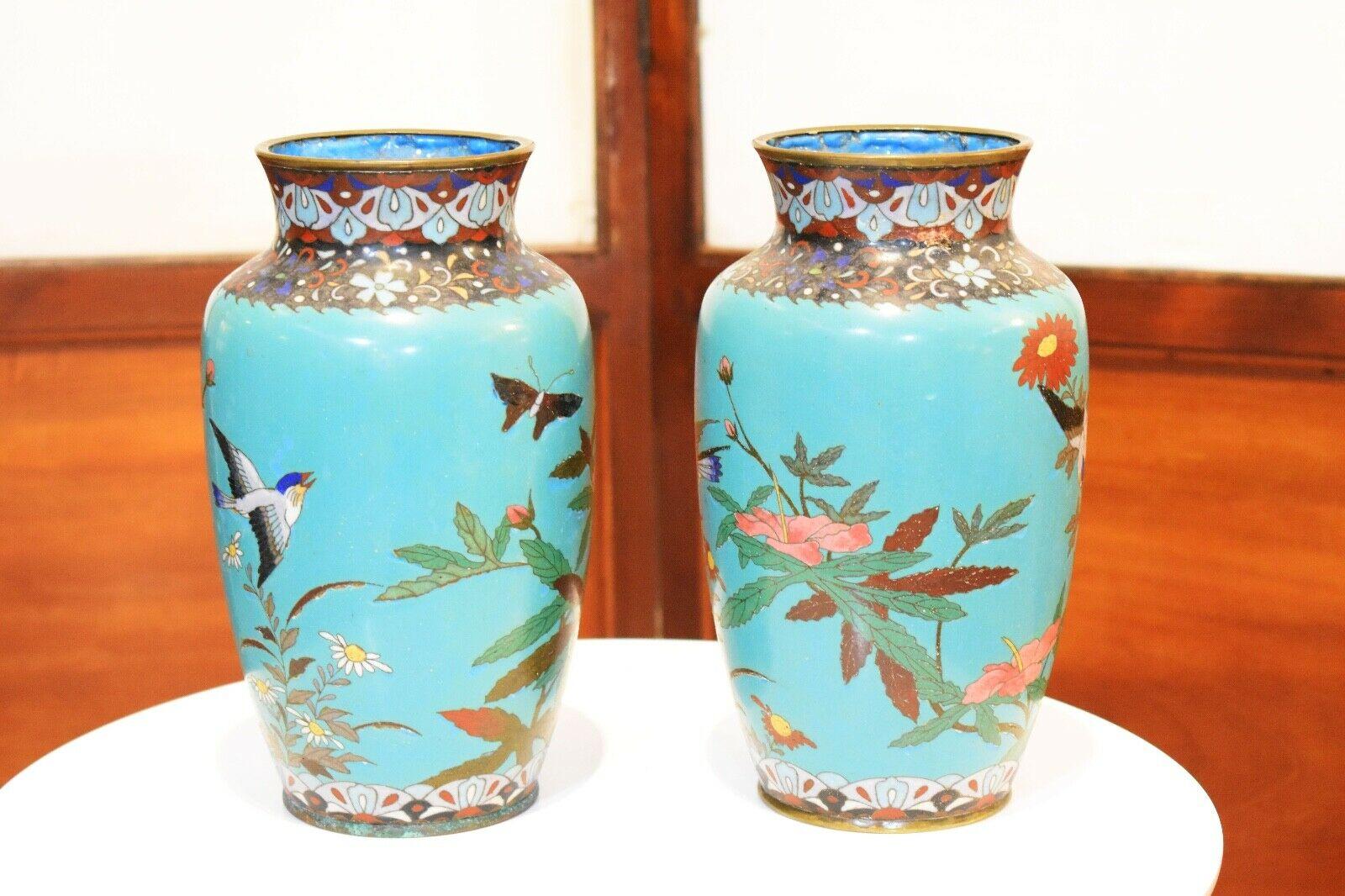 A beautiful pair of 19th century Japanese cloisonné vases

depicting a floral scene with birds on a turquoise color background. 

Very good antique condition, lovely patina and no chips or missing enamel.    
  