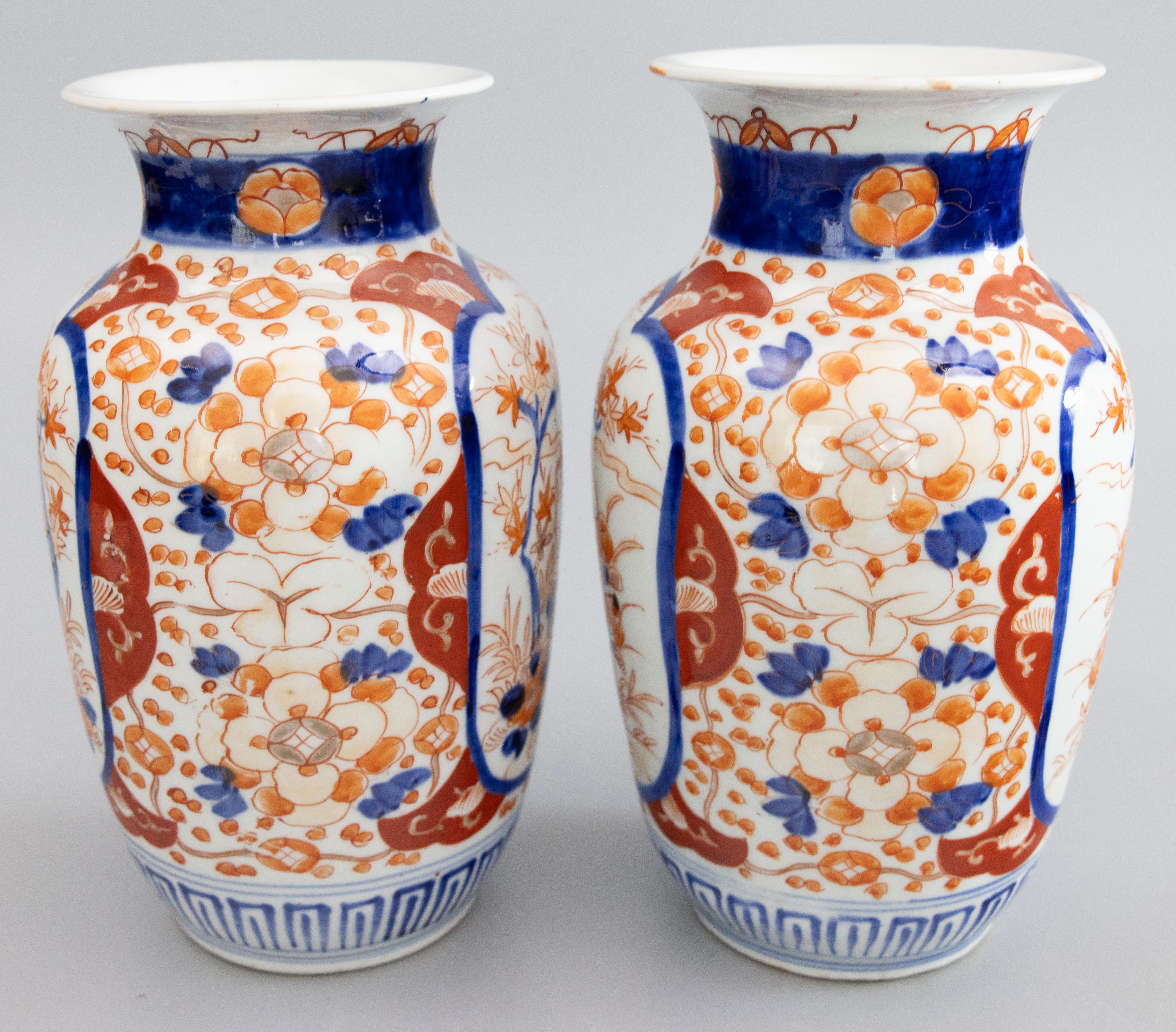 A gorgeous pair of 19th-Century Japanese Meiji Period Imari porcelain vases. These fine vases have a lovely shape and hand painted floral designs in the traditional Imari colors. They are in beautiful antique condition and would be fabulous for