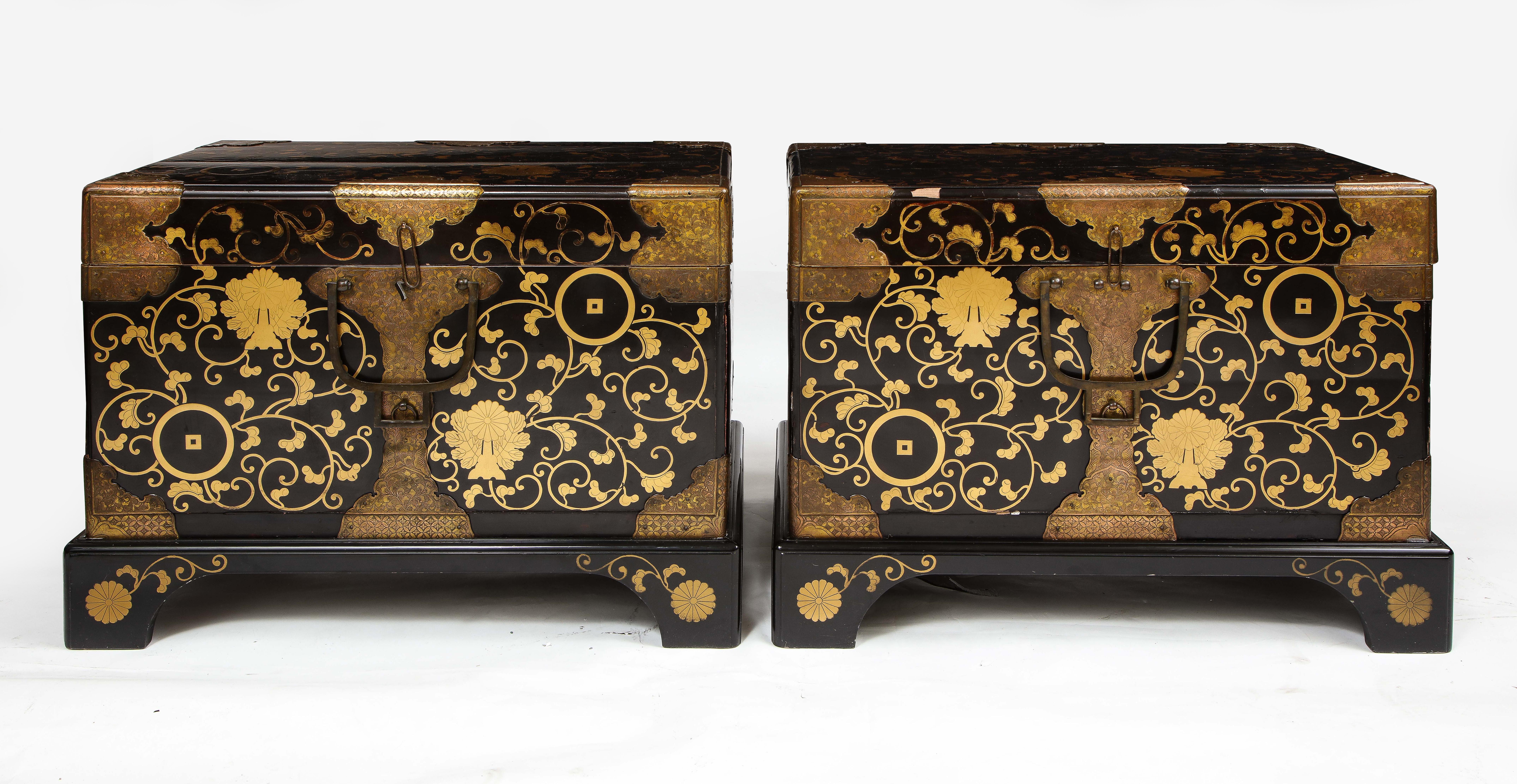 A Fine Pair of 19th Century Japanese Meiji Period Dore Bronze Mounted Lacquered Chests/Trunks.  Each chest is beautiful with a fine black lacquer which is heavily detailed and hand-painted with 24K gilt decoration of flowers and vines.  Both chests