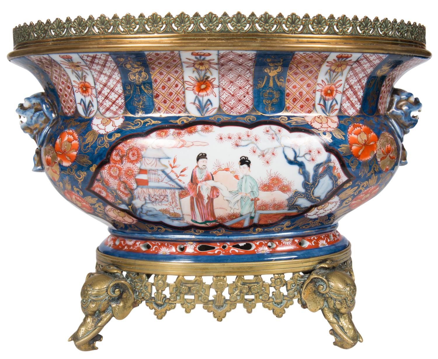 A good quality pair of Japanese style Samson 19th century Imari jardinières each having gilded galleries to the top, classical painted motifs, panels depicting figure in a garden, mythical dog of faux handles on either side, mounted on ormolu bases