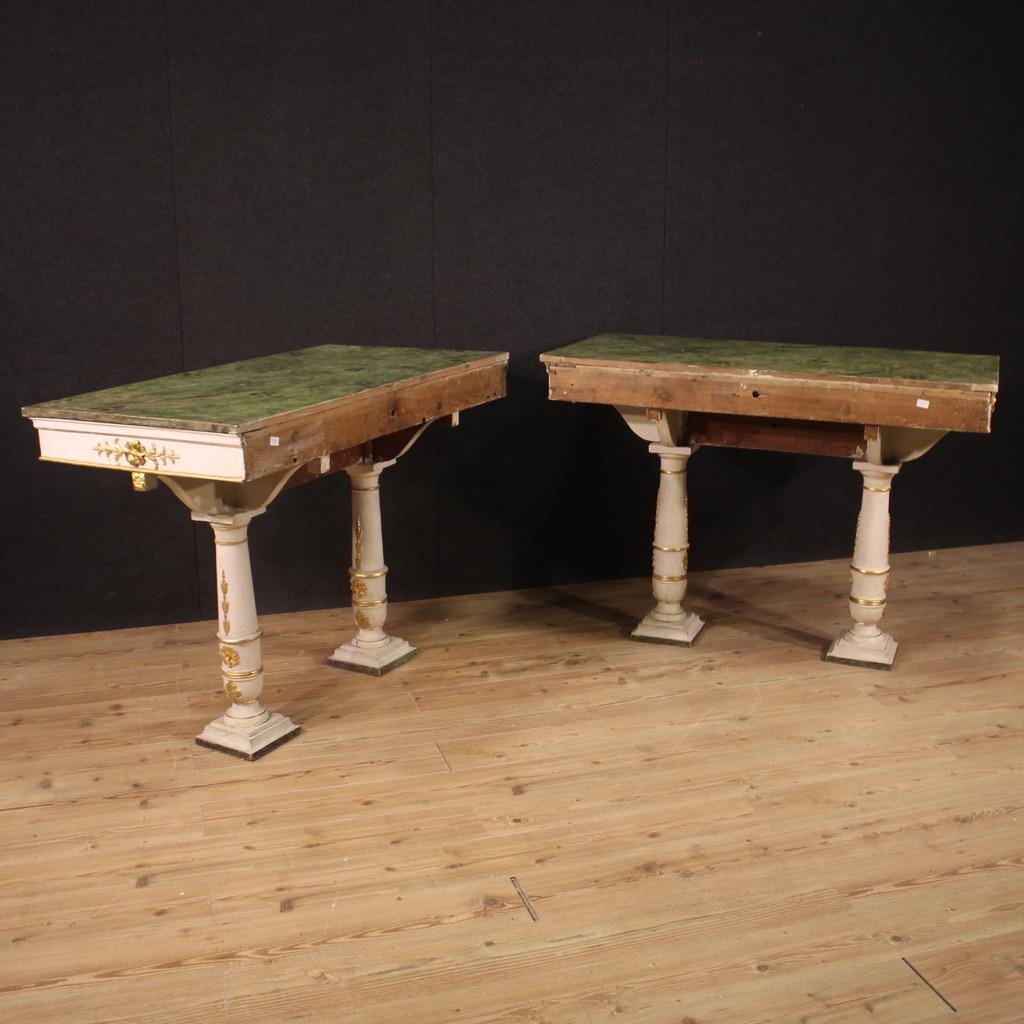 Pair of Genoese consoles from the end of the 19th century. Furniture in carved, lacquered, gilded and painted wood in Empire style with beautiful lines and pleasant furnishings. Pair of consoles to be fixed to the wall, ideal for placing in an