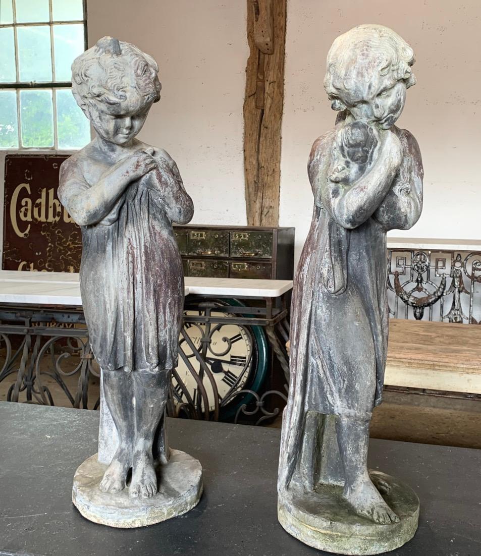 A beautiful pair of 19th century lead statues of a boy and girl. The boy is holding a bird and the girl is hugging a small dog. The lead has a nice aged patina. Price is for the pair.
A few old repairs in places. These will look great in the garden