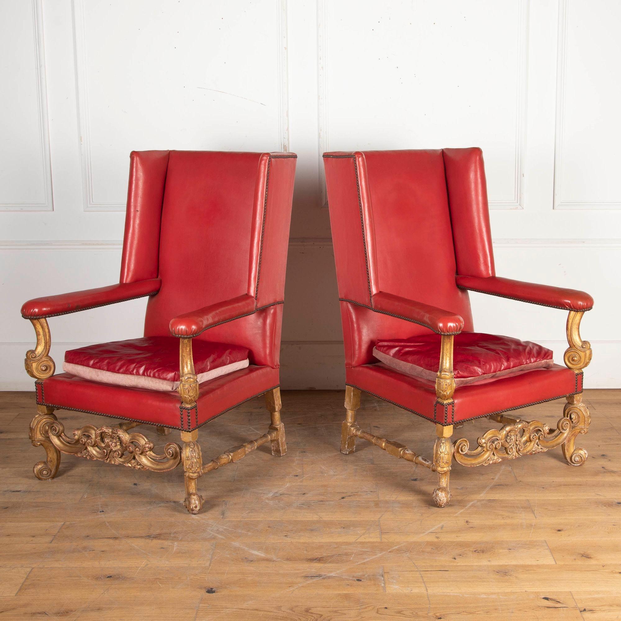 Pair of 19th century red leather wingback armchairs in the William and Mary style.
With a fabulous gilded frame and intricate carving, this pair of striking chairs make for perfect fireside armchairs.