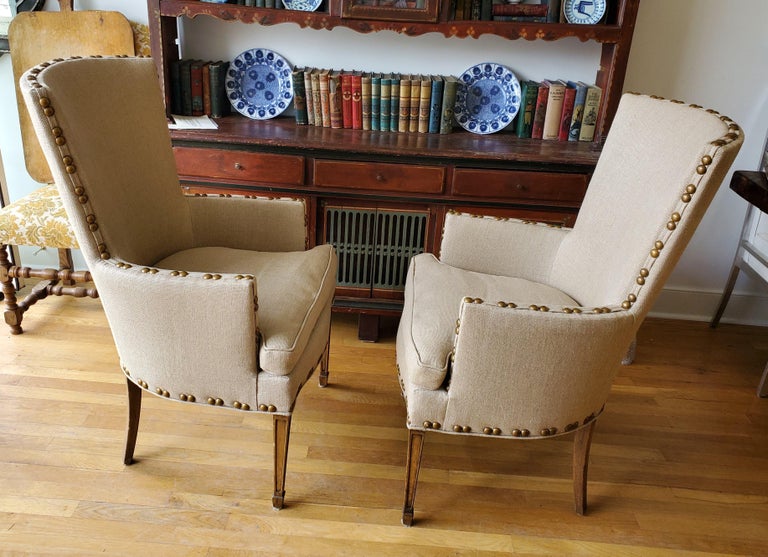 Pair of Elegant Mid-Century High Backed Armchairs.  Extremely comfortable with Sheraton style straight tapering legs. Recently reupholstered with nail heads. 
Measure: 42” H   25” W   28” D 


 