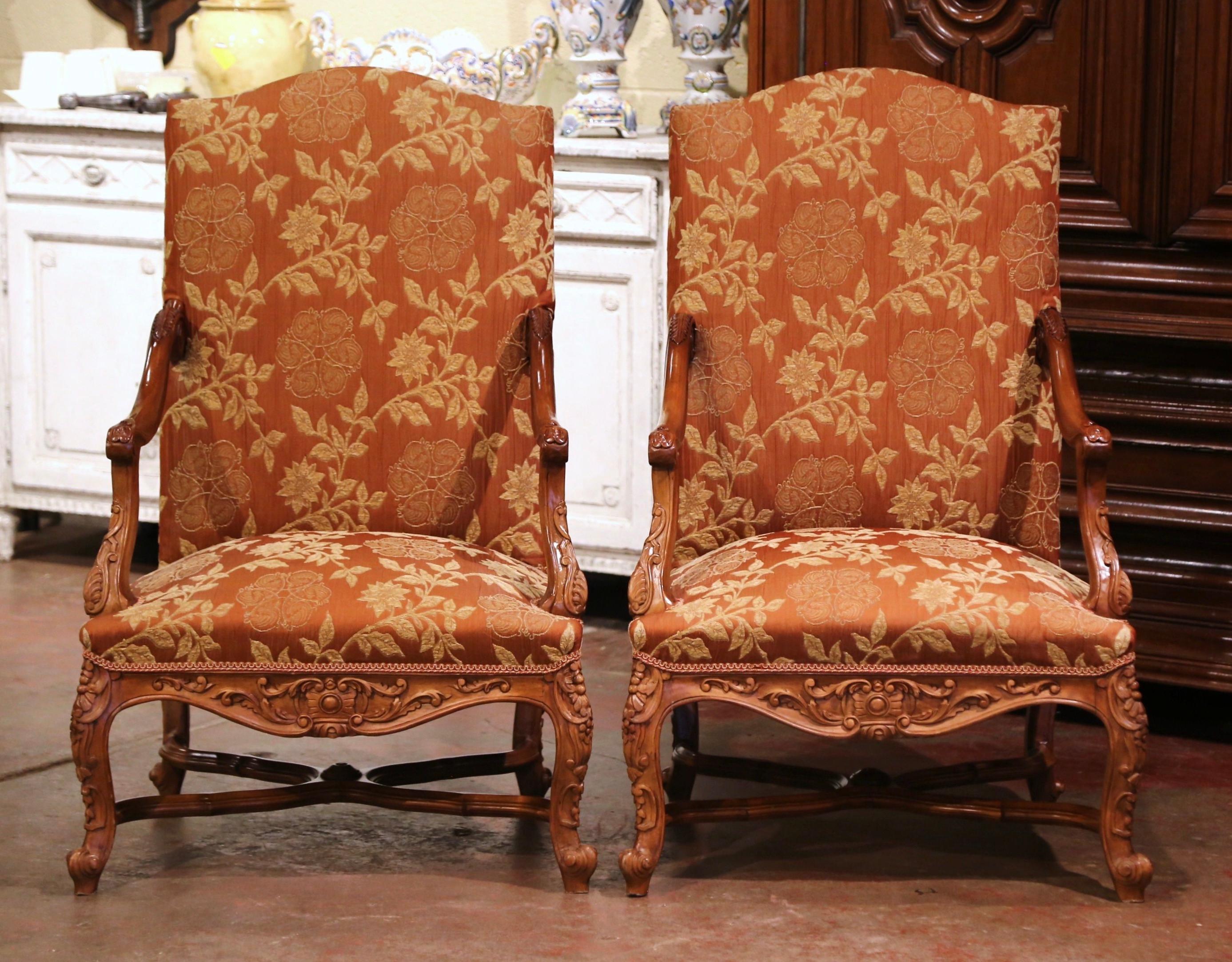 Crafted in Provence, France circa 1880, each comfortable fauteuil sits on cabriole legs decorated with acanthus leaves at the shoulder, and ending with escargot feet over an X-form stretcher. Both armchairs have a tall and arched back, a wide and