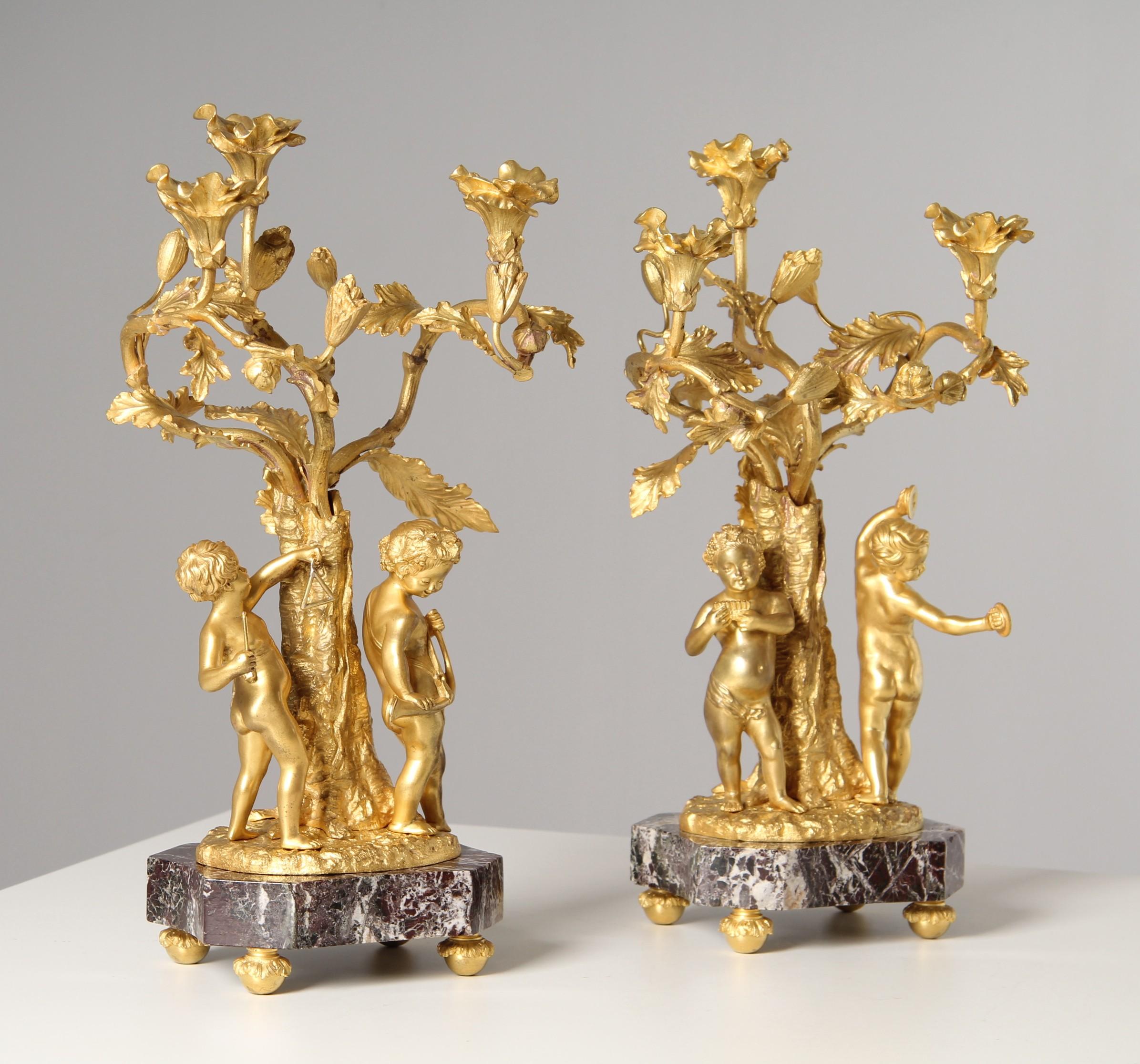 Pair of candlesticks with putti playing music

France
Ormolu
second half of the 19th century.

Dimensions: approx. H x W x D: 40 x 22 x 20 cm

Description:
This extraordinary pair of French candlesticks was designed in the opulent and playful Rococo