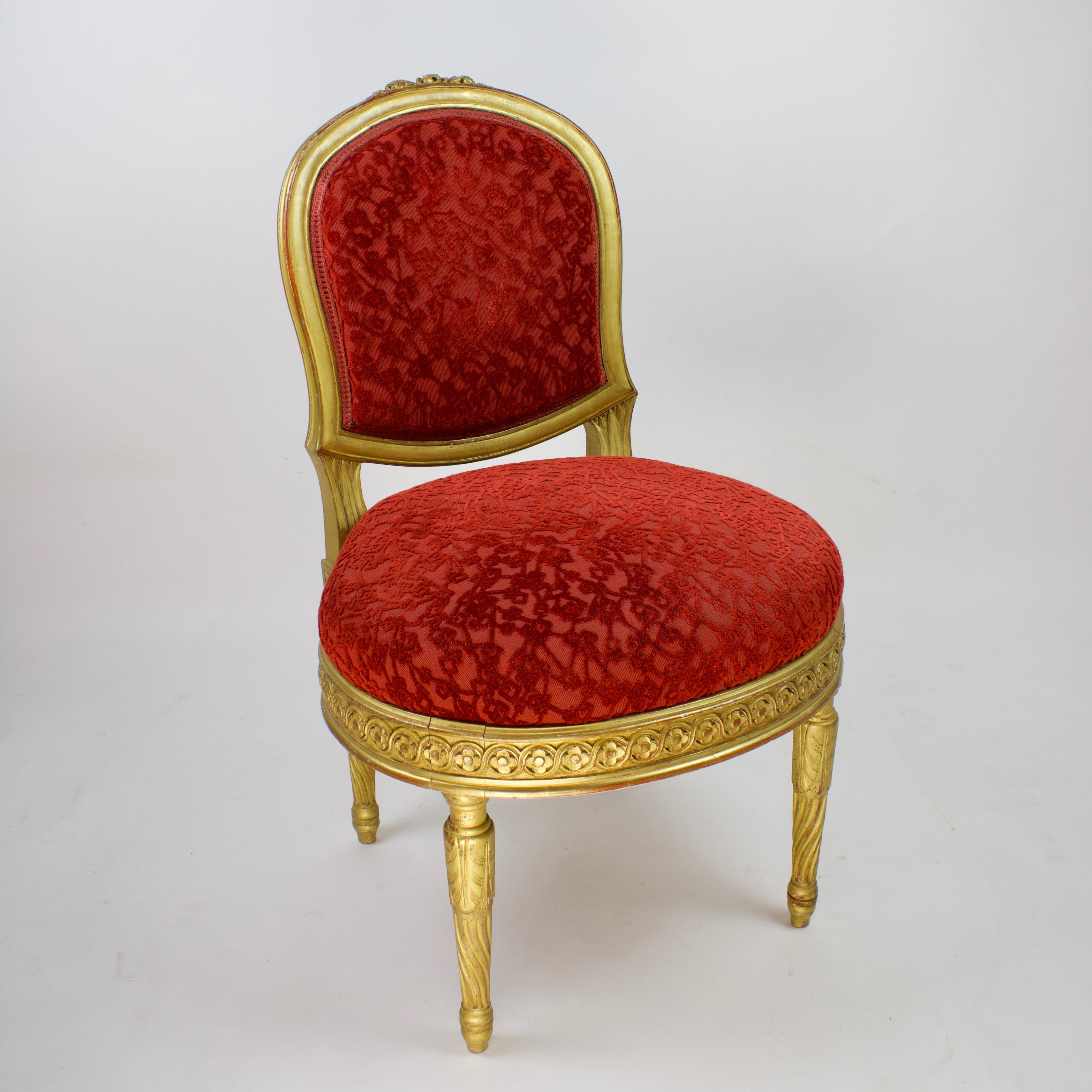 Pair of decorative 19th Century Napoleon III Louis XVI Style gilt wood side chairs

An arched padded back with carved flower decoration and a broad padded seat of oval shape, the frame of the seat carved with neoclassical wave frieze, on fluted