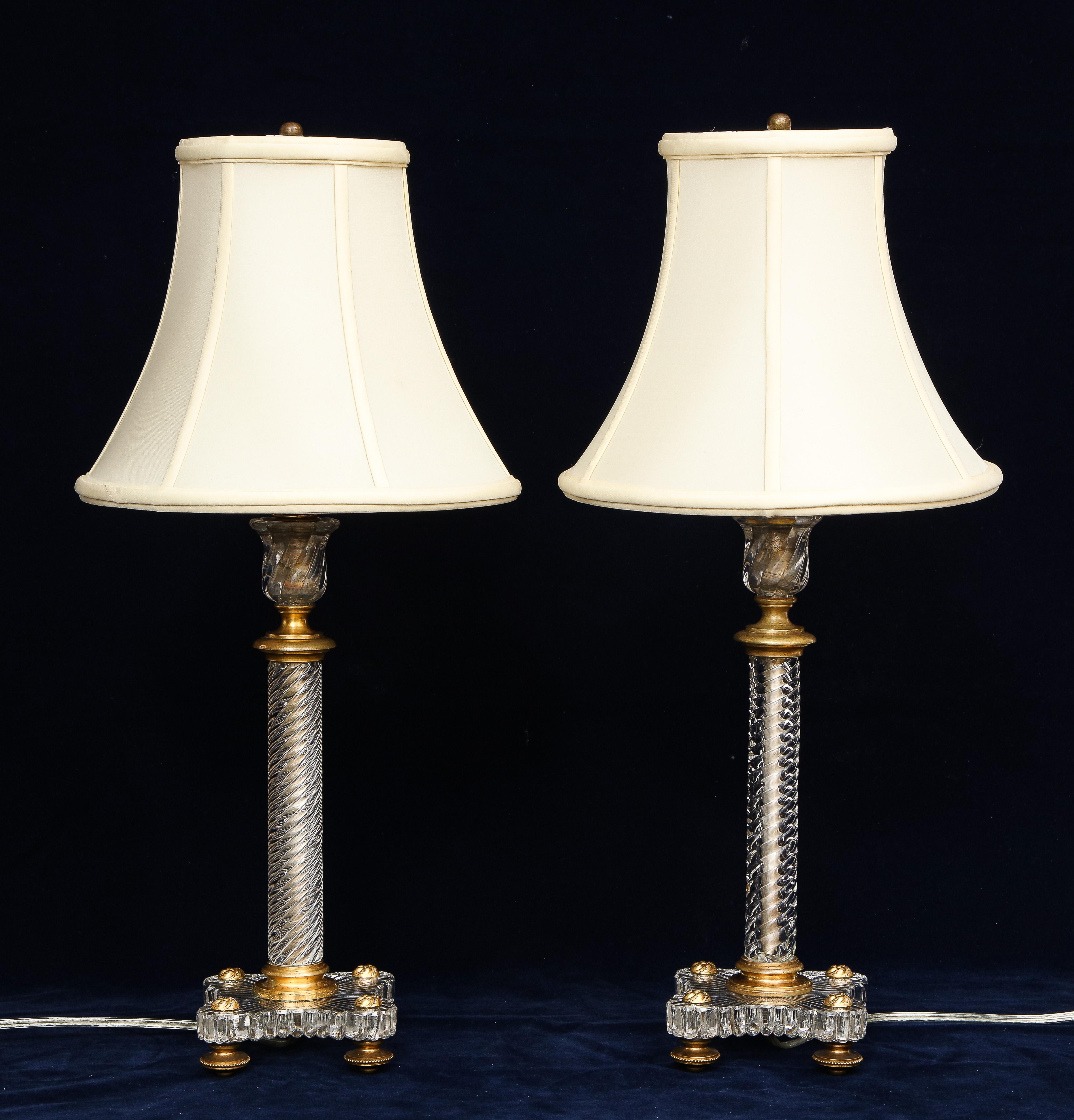A Pair of 19th Century Louis XVI Style French Dore Bronze Mounted Baccarat Swirling Crystal Table Lamps.  Each piece is beautiful with the finest and most dense French Baccarat Crystal.  They have a wonderful swirling design and the base is