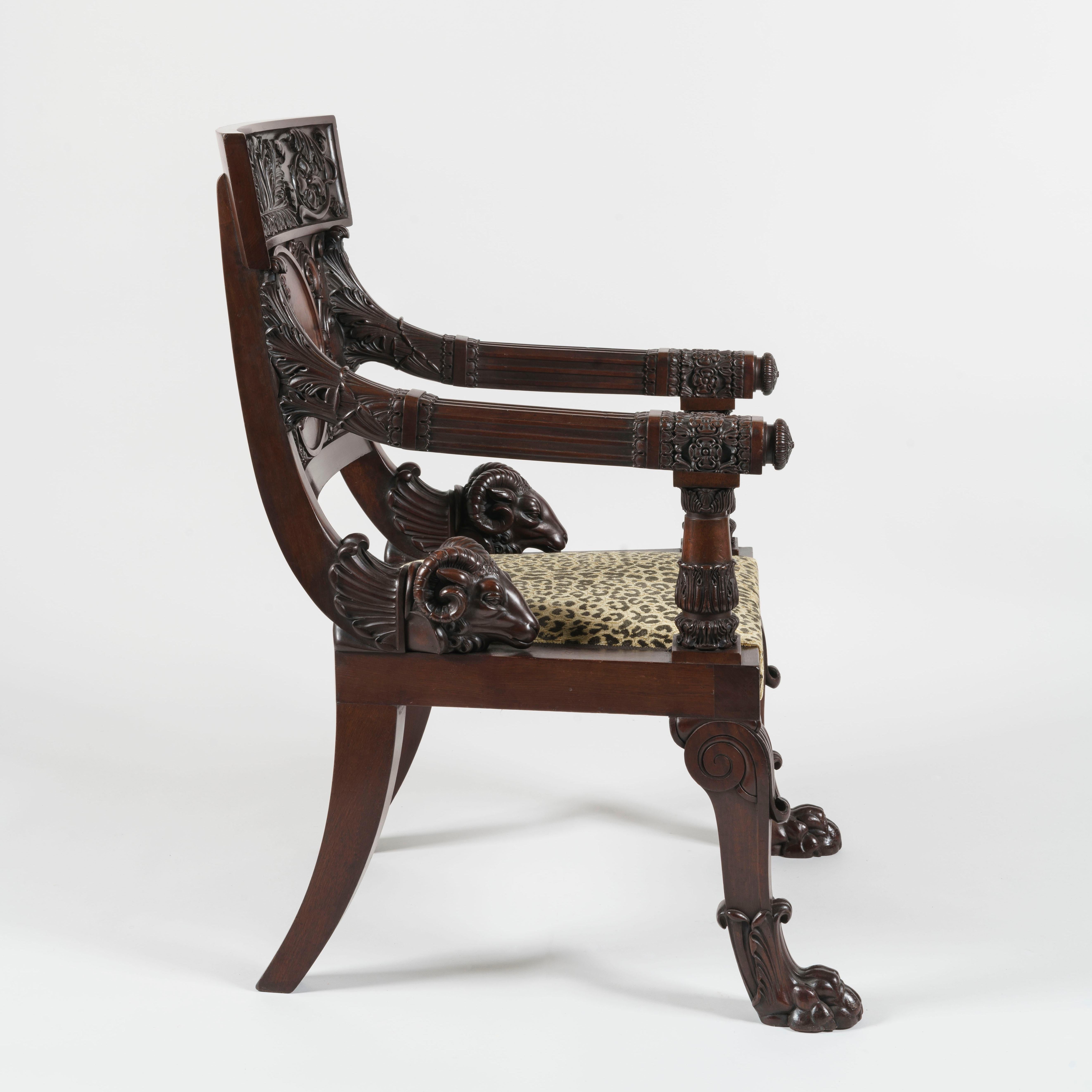 A pair of Klismos armchairs of important size
After a design by Thomas Hope

Constructed in a finely patinated Cuban mahogany, dressed with the carved Burnell family crest; rising from claw footed swept and lapetted legs, with sabre legs to the