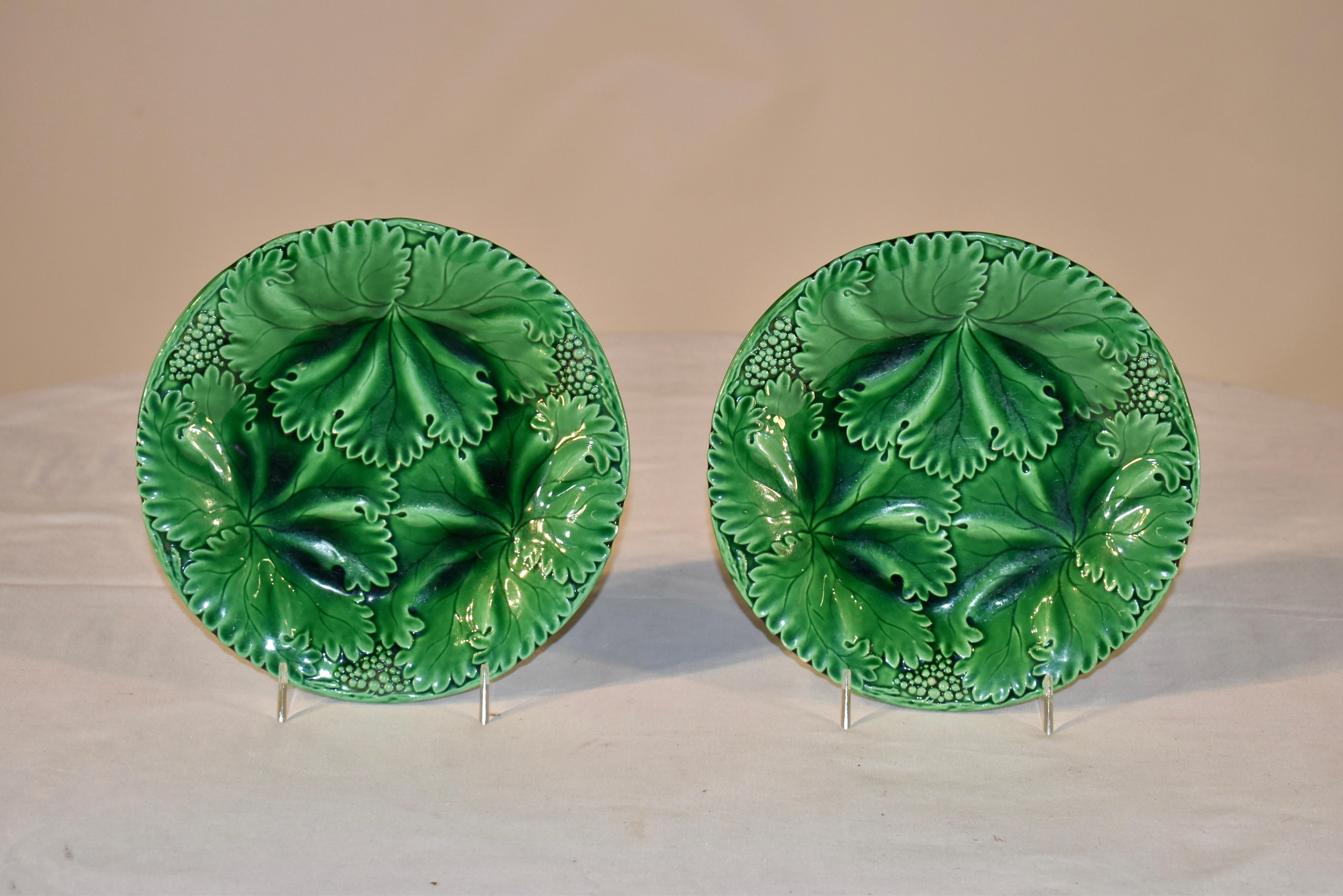 Pair of 19th century majolica plates stamped with the makers mark Schramberg on the back. They are wonderfully colored and are in the design of three overlapping leaves , with berries and vines separating them around the rim of the plate.